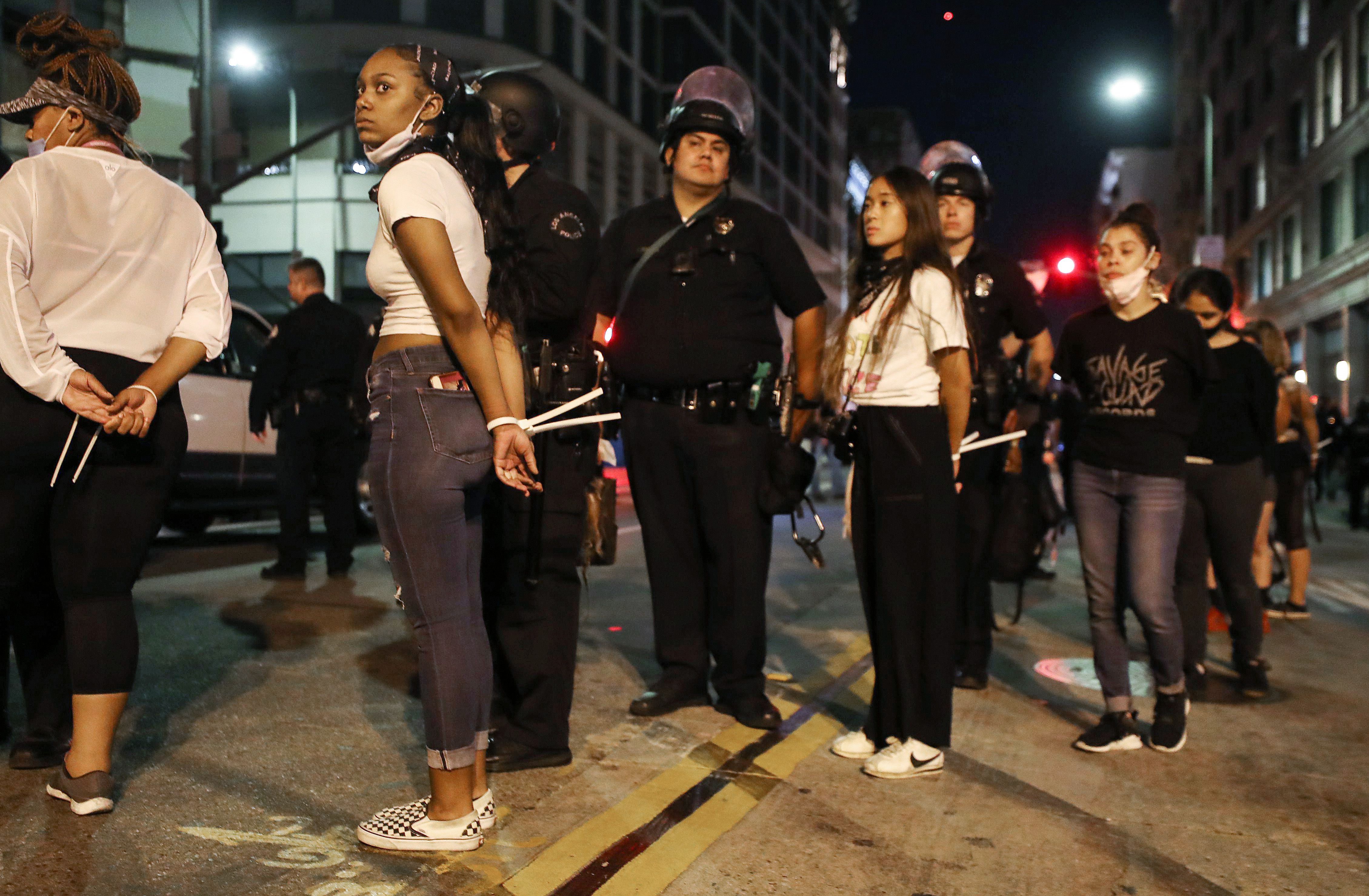 Women are arrested downtown by police after curfew went into effect during demonstrations over George Floyd’s death on June 2, 2020 in Los Angeles, California. Mario Tama—Getty Images