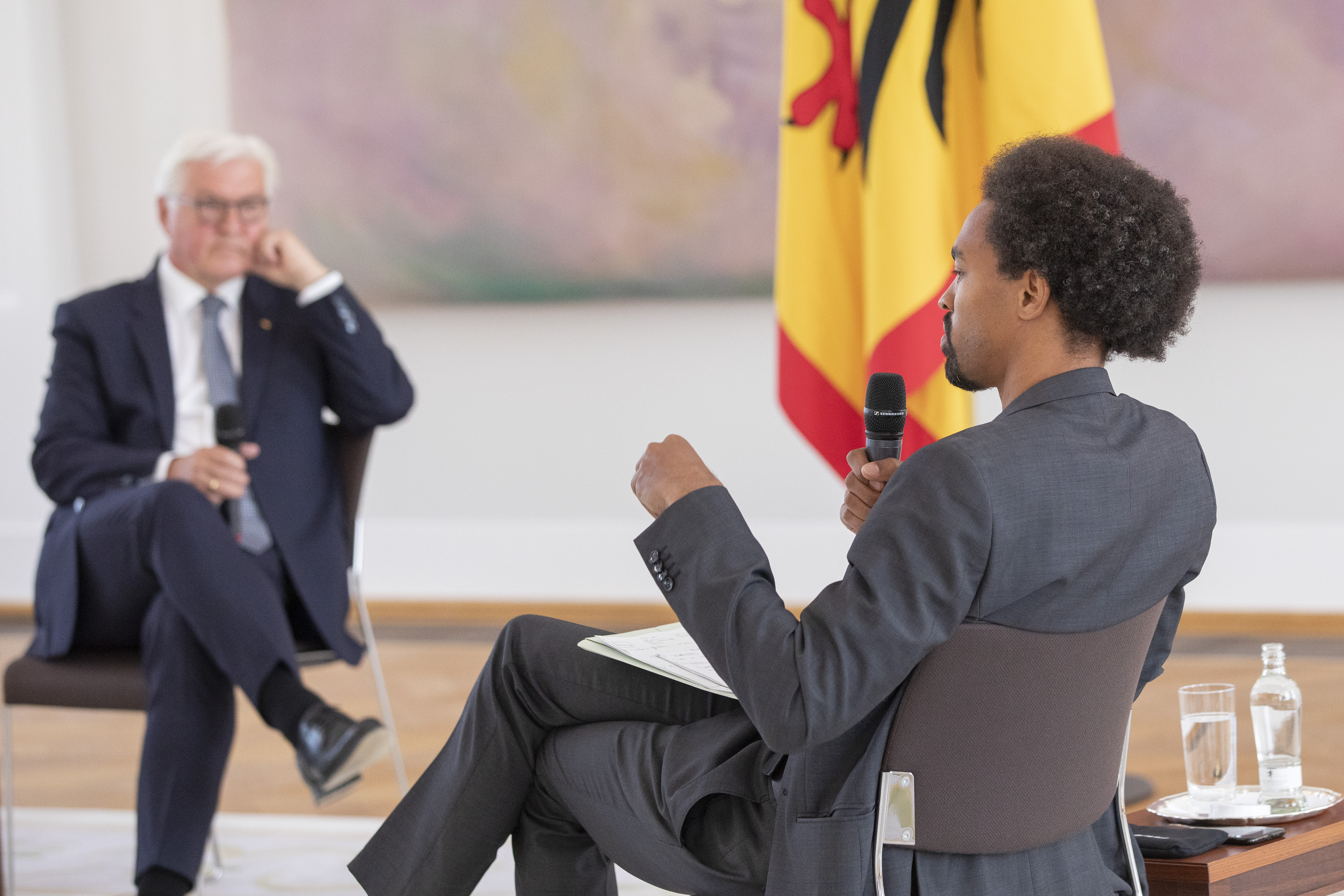German President Frank-Walter Steinmeier (L) speaks with Daniel Gyamerah division manager of Think-Tanks "Citizens For Europe" in Berlin while hosting a discussion on racism in Germany at Schloss Bellevue palace on June 16, 2020 in Berlin, Germany. German cities have seen their own share of protests against racism and police violence since the death of George Floyd in the USA.