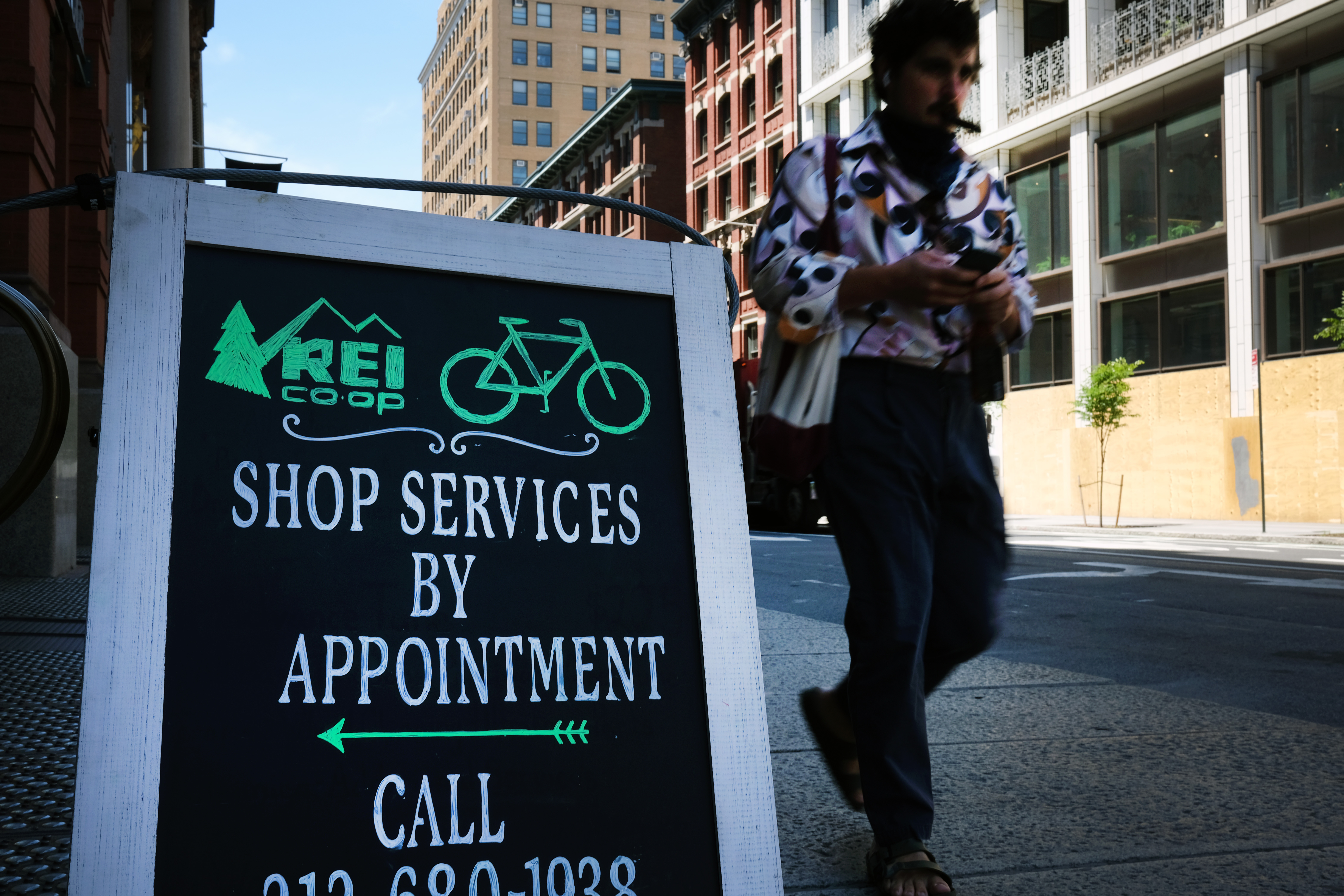 A sign advertises stores continue to reopen across the United States. The Commerce Department on Tuesday announced retail sales rose 17.7% in May from the previous month, well above the 8% forecast. Wire photography: Spencer Platt—Getty Images