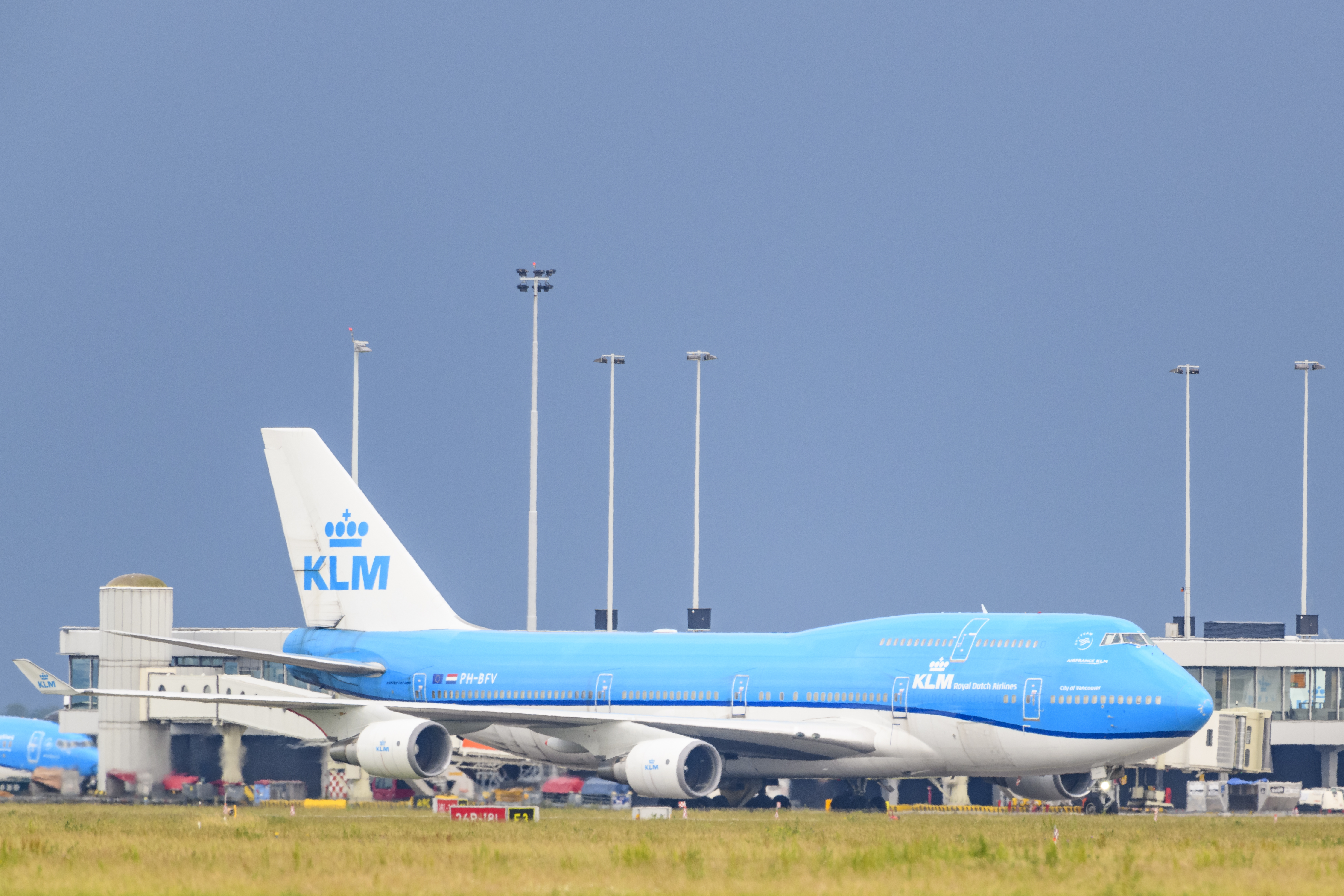 KLM (Koninklijke Luchtvaart Maatschappij - Royal Dutch Airlines) Boeing 747 Jumbojet passing in front of the airfield buildings on June 18 near Amsterdam,Netherlands.