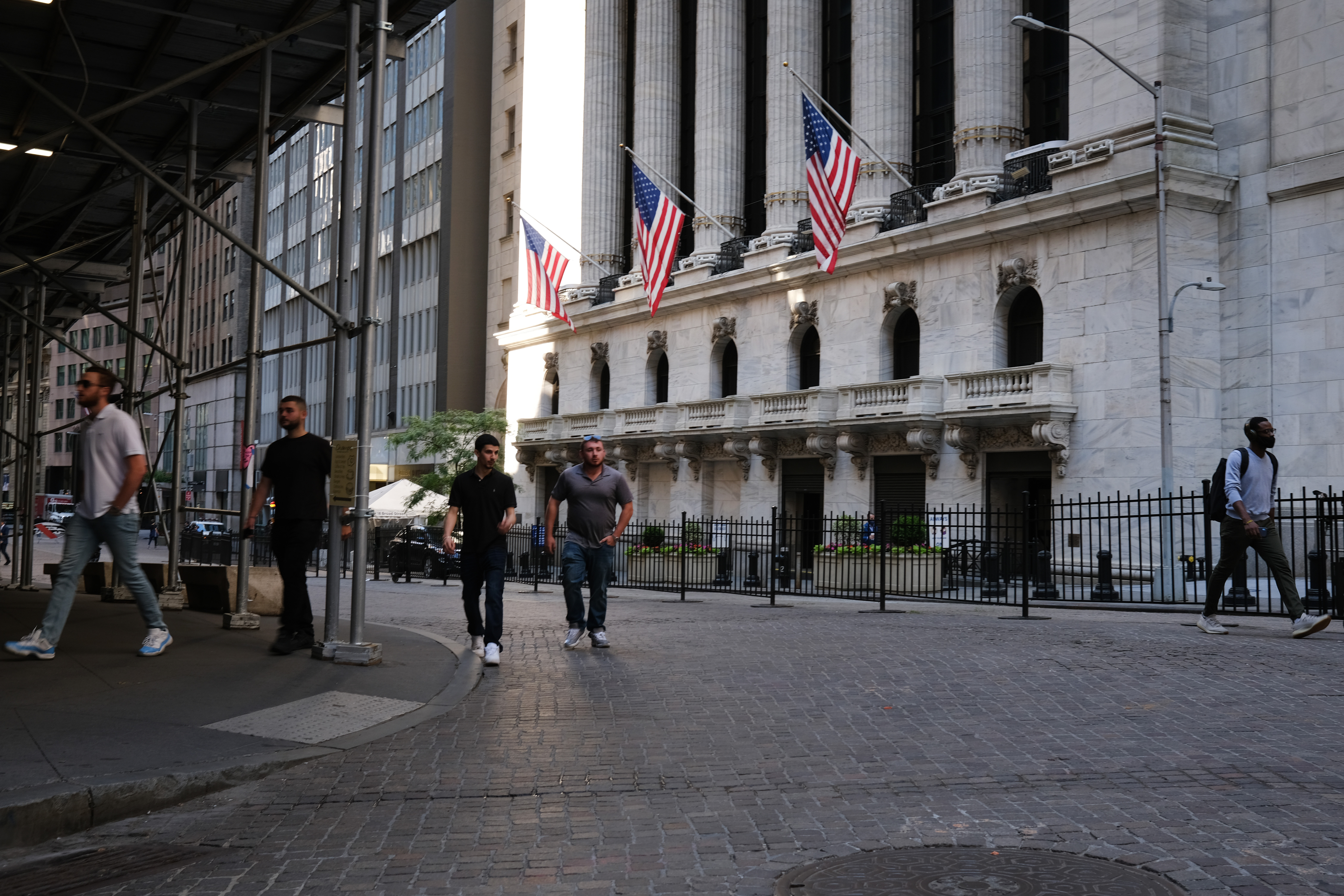 People walk by the New York Stock Exchange as Manhattan enters Phase 2 of re-opening. U.S. futures are slumping on Wednesday, putting the stocks rally in jeopardy. Wire photography: Spencer Platt—Getty Images
