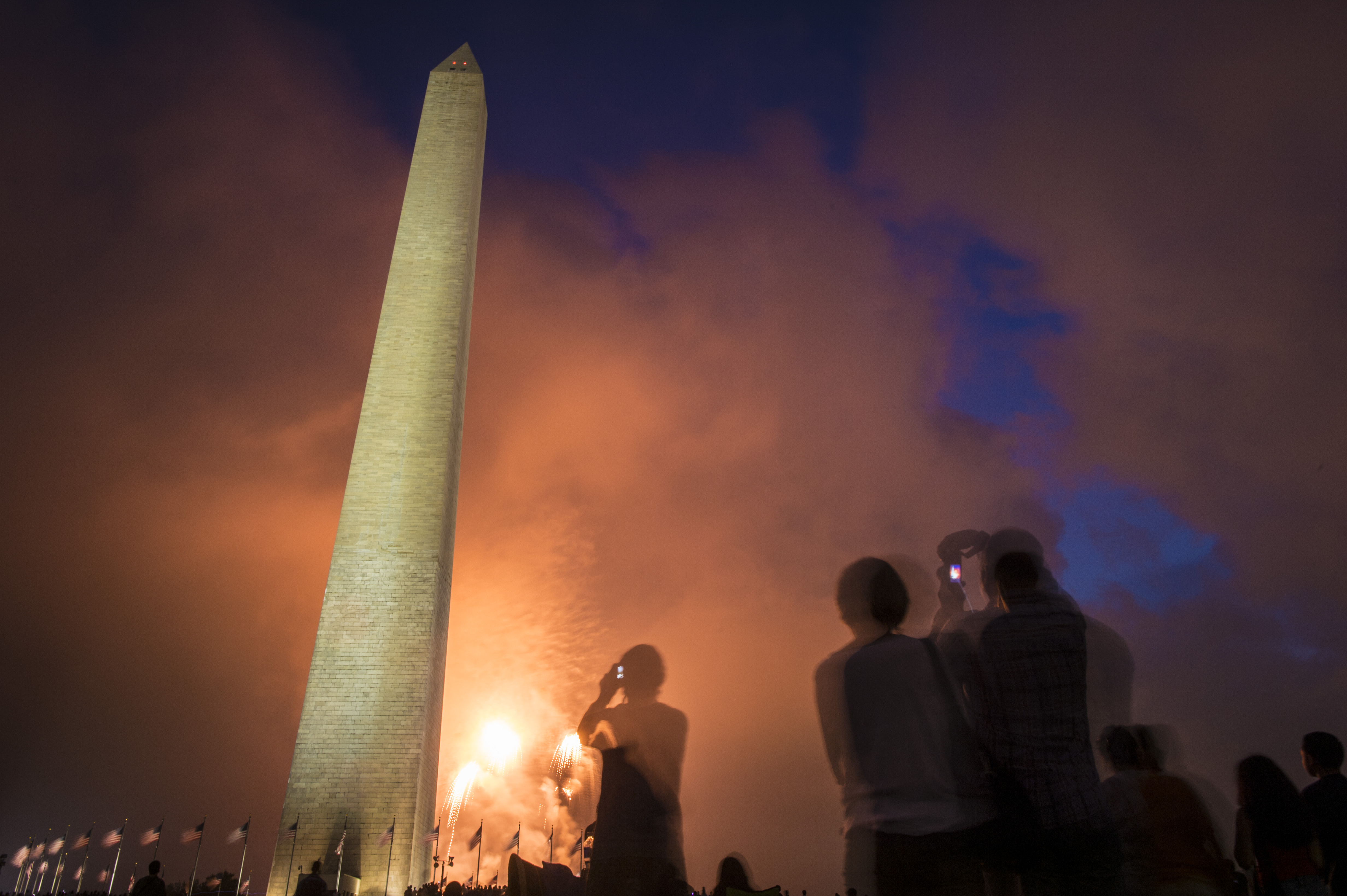 WASHINGTON, DC - JULY 4: People watch fireworks near the Washington Monument on the National Mall during the Fourth of July celebrations in Washington, DC on Saturday, July 04, 2015. (Photo by Jabin Botsford/The Washington Post via Getty Images)