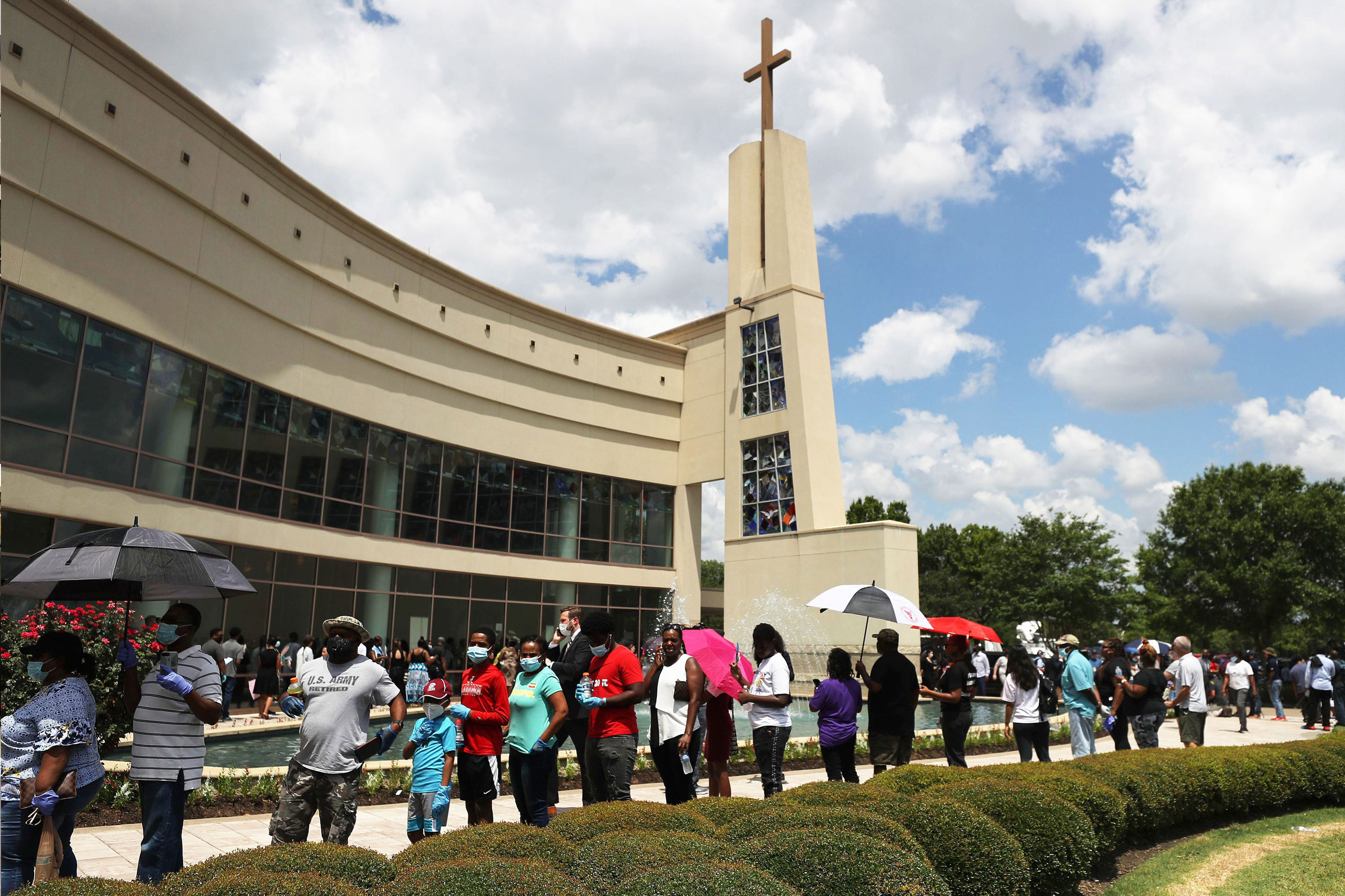 People wait in line to attend the public memorial for George Floyd outside the Fountain of Praise church on June 8, 2020 in Houston, Texas. Mario Tama—Getty Images