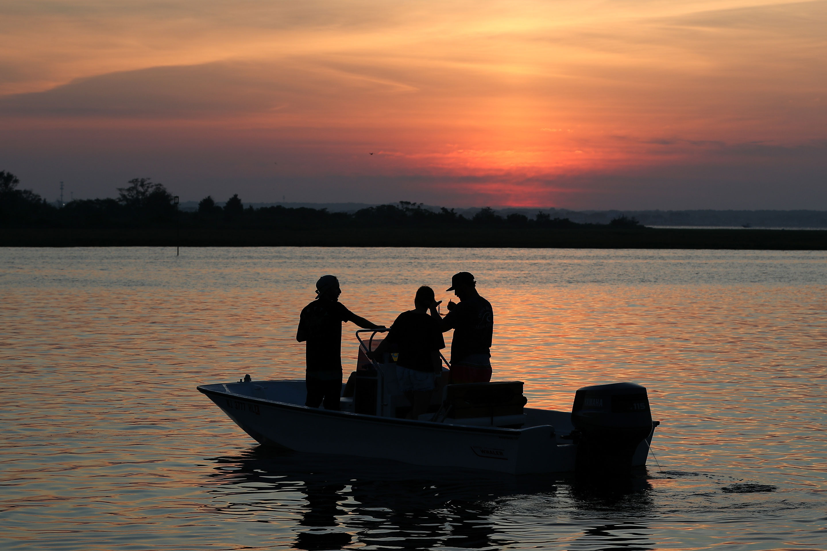 : A boat floats in the sear near the Seaside Heights during sunset in Jersey Shore, New Jersey, United States on July 18, 2020. (Photo by Tayfun Coskun/Anadolu Agency via Getty Images)
