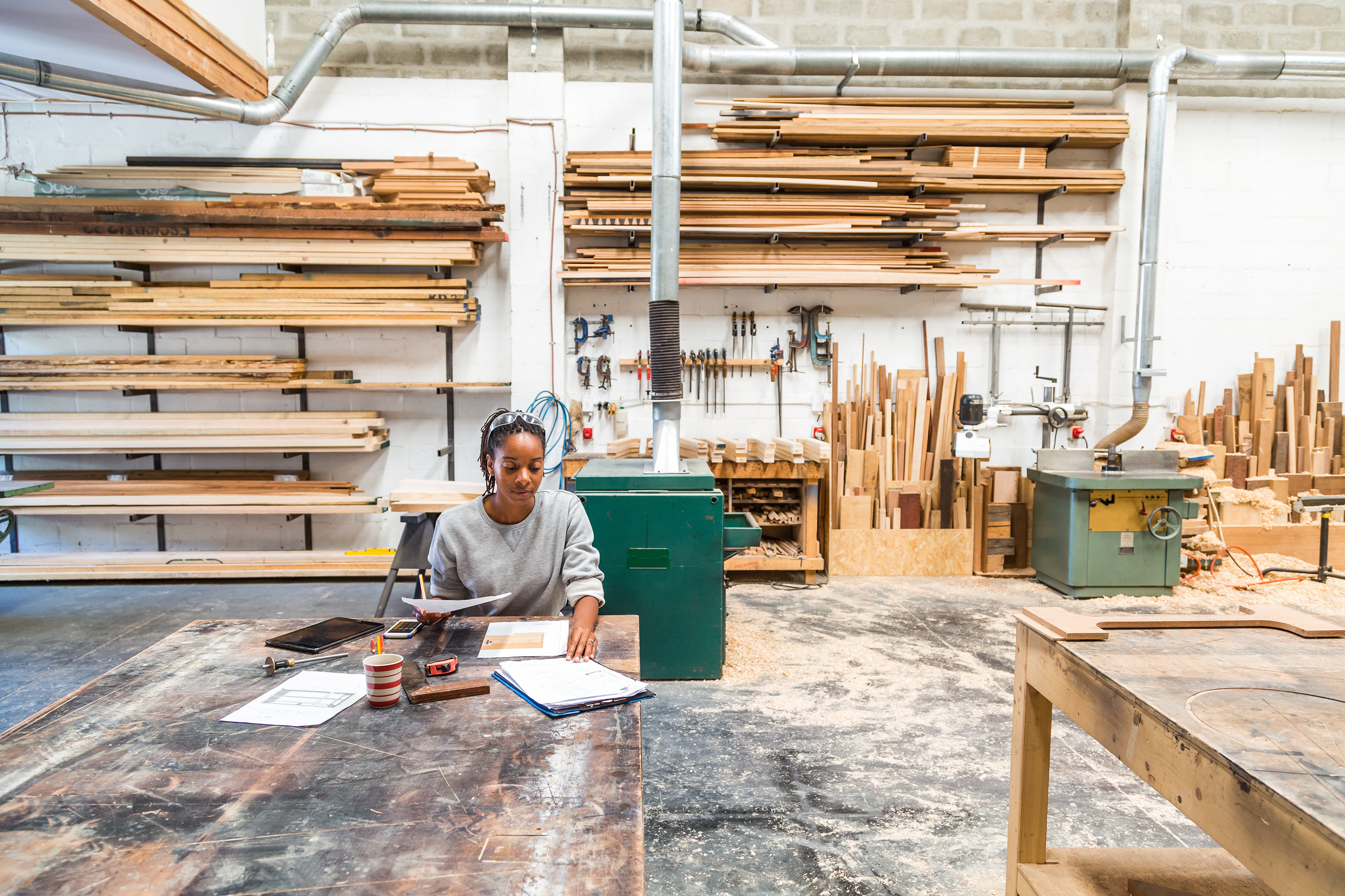 Young black female designer working in a woodworking workshop