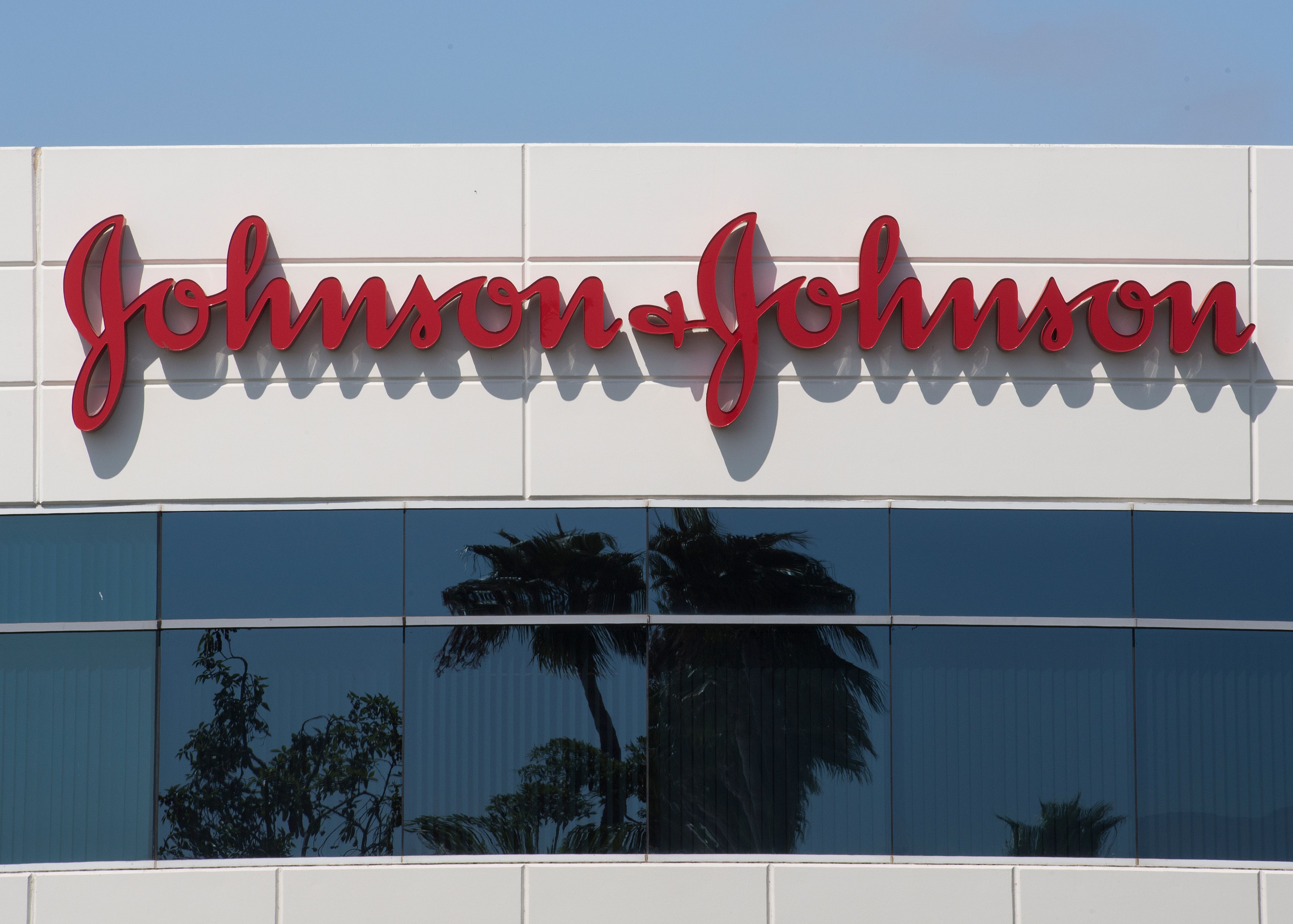 A sign on a building at the Johnson & Johnson campus shows their logo in Irvine, California on August 28, 2019. - The US pharmaceutical industry faces tens of billions of dollars in potential damage payments for fueling the opioid addiction crisis after Oklahoma won a $572 million judgment against drugmaker Johnson & Johnson. (Photo by Mark RALSTON / AFP) (Photo credit should read MARK RALSTON/AFP via Getty Images)