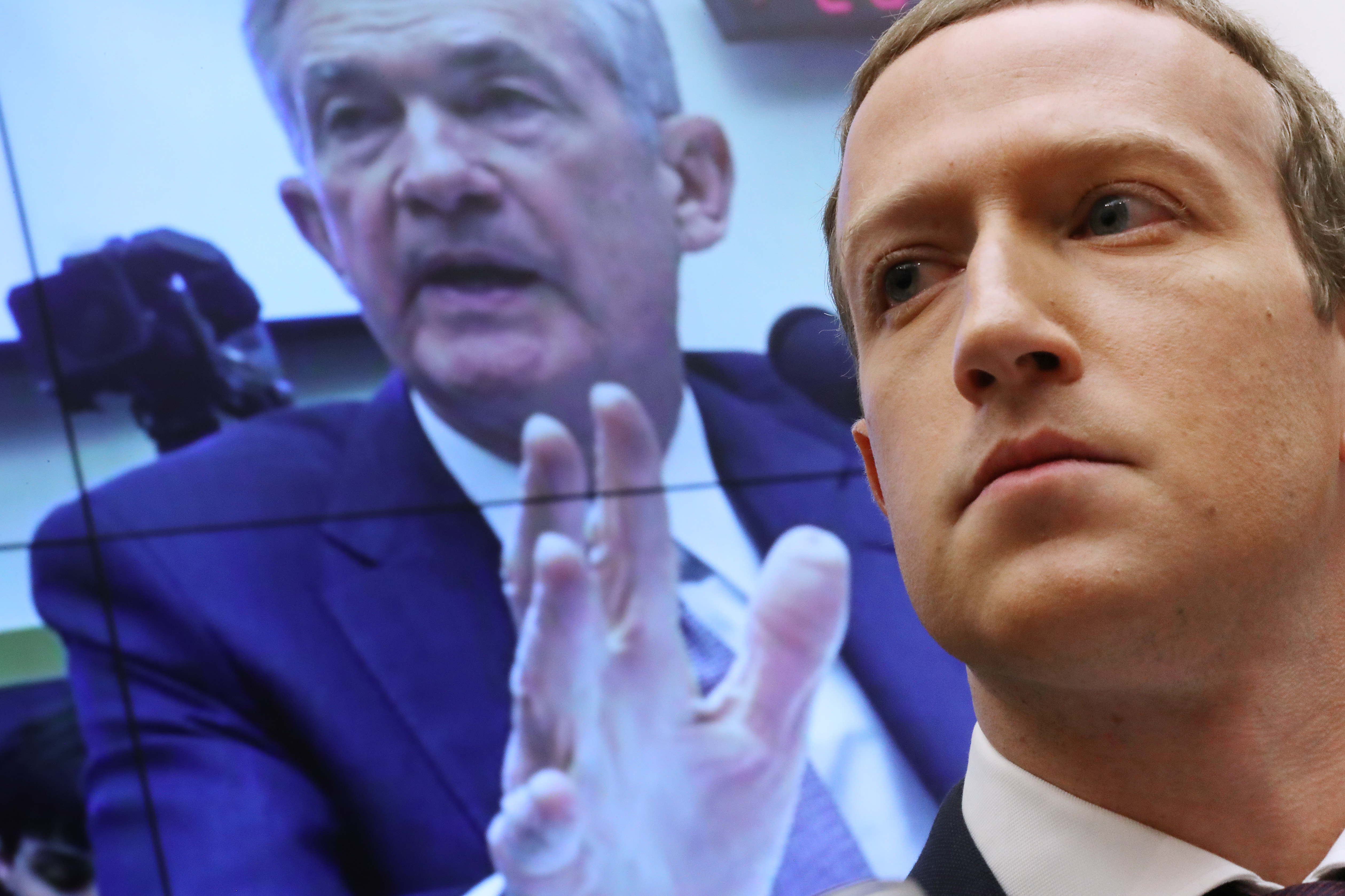With an image of Federal Reserve Bank Chairman Jerome Powell on a screen in the background, Facebook co-founder and CEO Mark Zuckerberg testifies before the House Financial Services Committee in the Rayburn House Office Building on Capitol Hill October 23, 2019 in Washington, DC. Zuckerberg testified about Facebook's proposed cryptocurrency Libra, how his company will handle false and misleading information by political leaders during the 2020 campaign and how it handles its users’ data and privacy. (Photo by Chip Somodevilla/Getty Images)