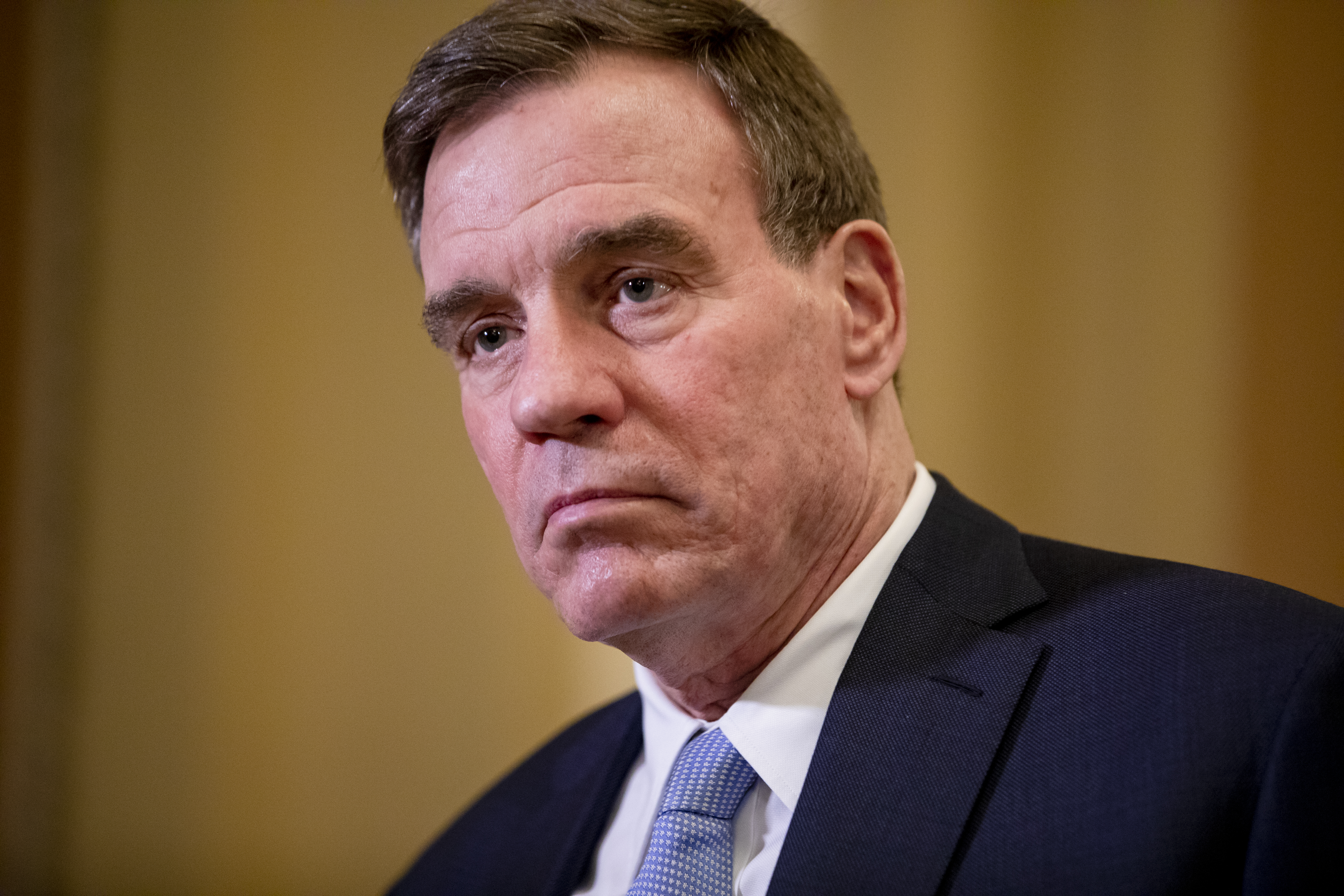 WASHINGTON, DC - JANUARY 30: Sen. Mark Warner (D-VA) returns to the Senate floor following a recess in the Senate impeachment trial of President Donald Trump on January 30, 2020 in Washington, DC. The trial has entered into the second day of the question phase where Senators have the opportunity to submit written questions to the House managers and President Trump's defense team. (Photo by Samuel Corum/Getty Images)