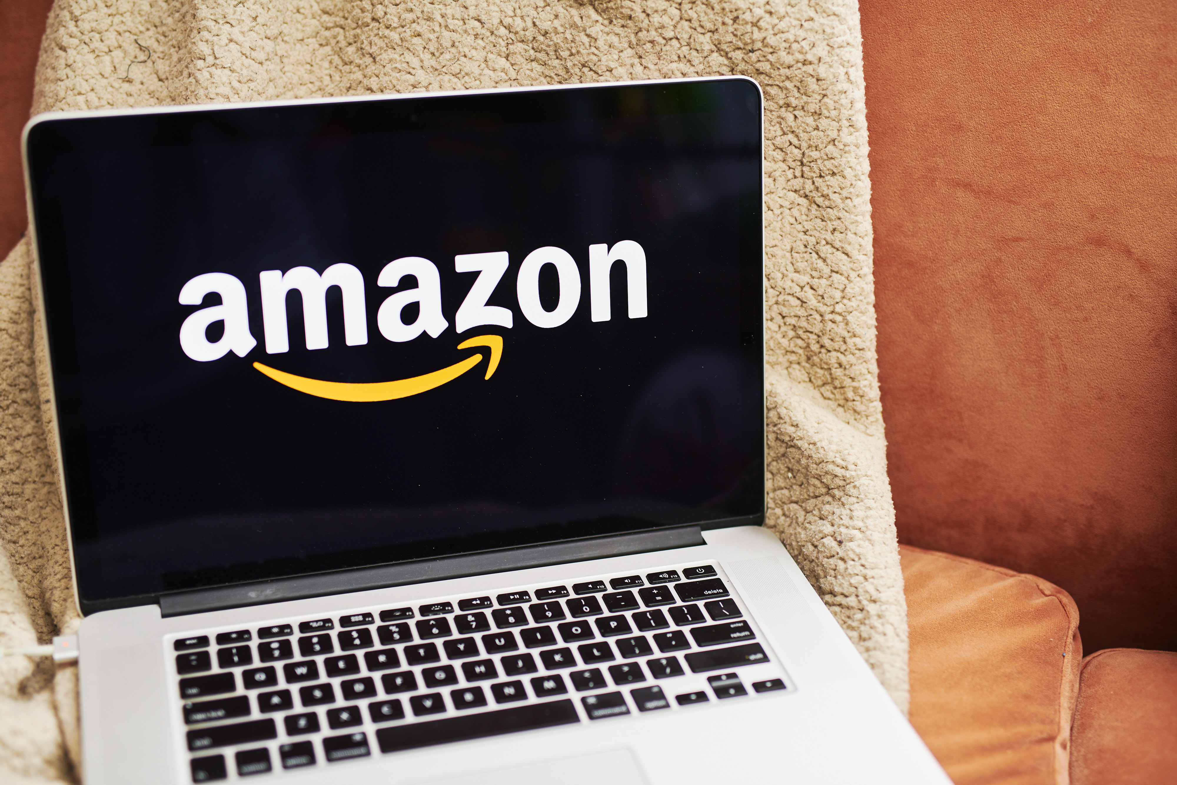 The logo for Amazon.com Inc. is displayed on an Apple Inc. laptop computer in an arranged photograph taken in the Brooklyn borough of New York, U.S., on Friday, April 10, 2020. Across the country, millions of consumers are turning to Amazon.com and other services to fill their fridges via online delivery rather than brave going to a supermarket because of shelter-in-place declarations during the coronavirus pandemic. Photographer: Gabby Jones/Bloomberg via Getty Images
