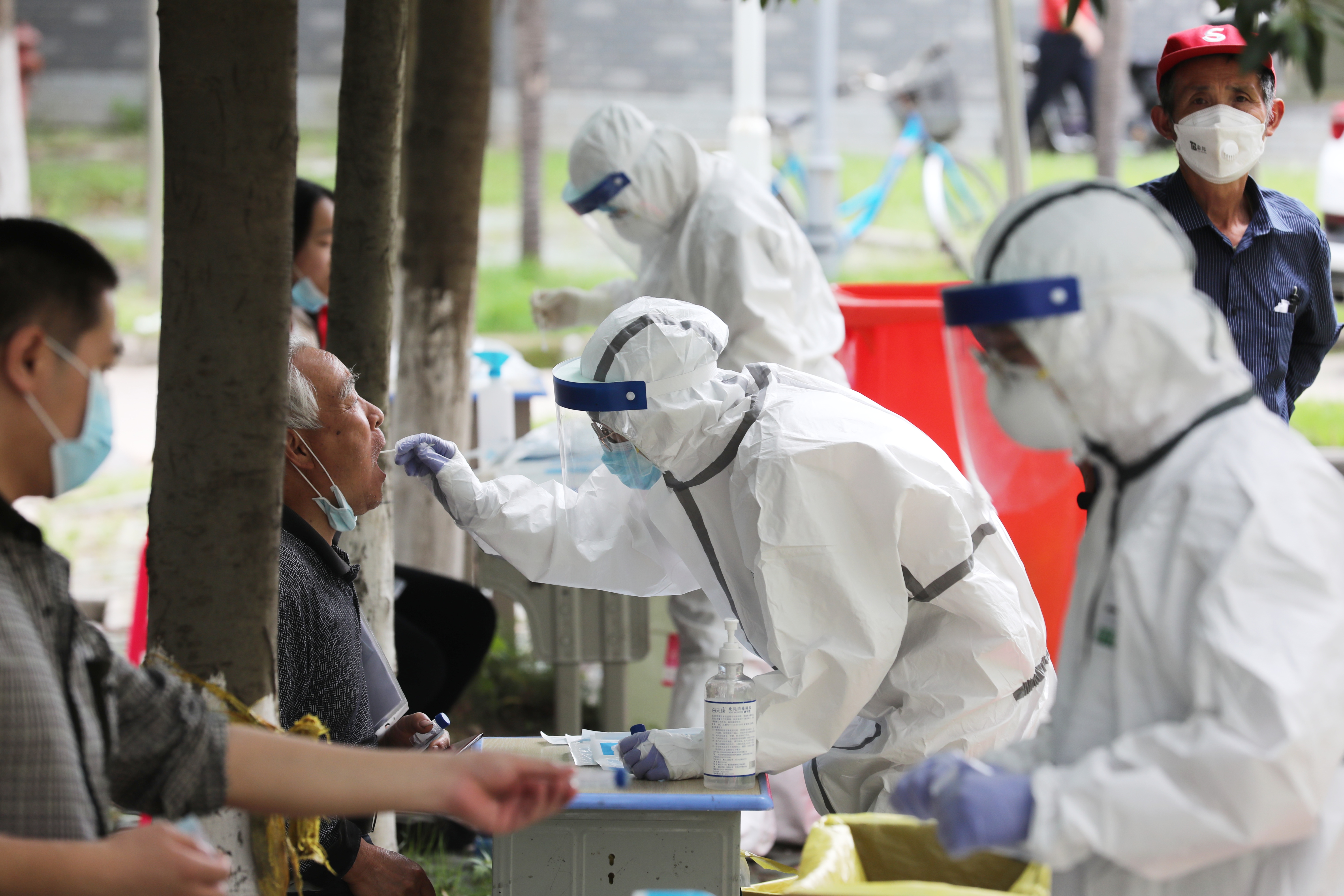 WUHAN, CHINA - MAY 16 2020: A medical worker takes a swab from an old man for the novel coronavirus test during a mission in a residential block in Wuhan in central China's Hubei province Saturday, May 16, 2020. The city plans to test all its citizens, over 11 million people, within 10 days.- PHOTOGRAPH BY Feature China / Barcroft Studios / Future Publishing (Photo credit should read Feature China/Barcroft Media via Getty Images)