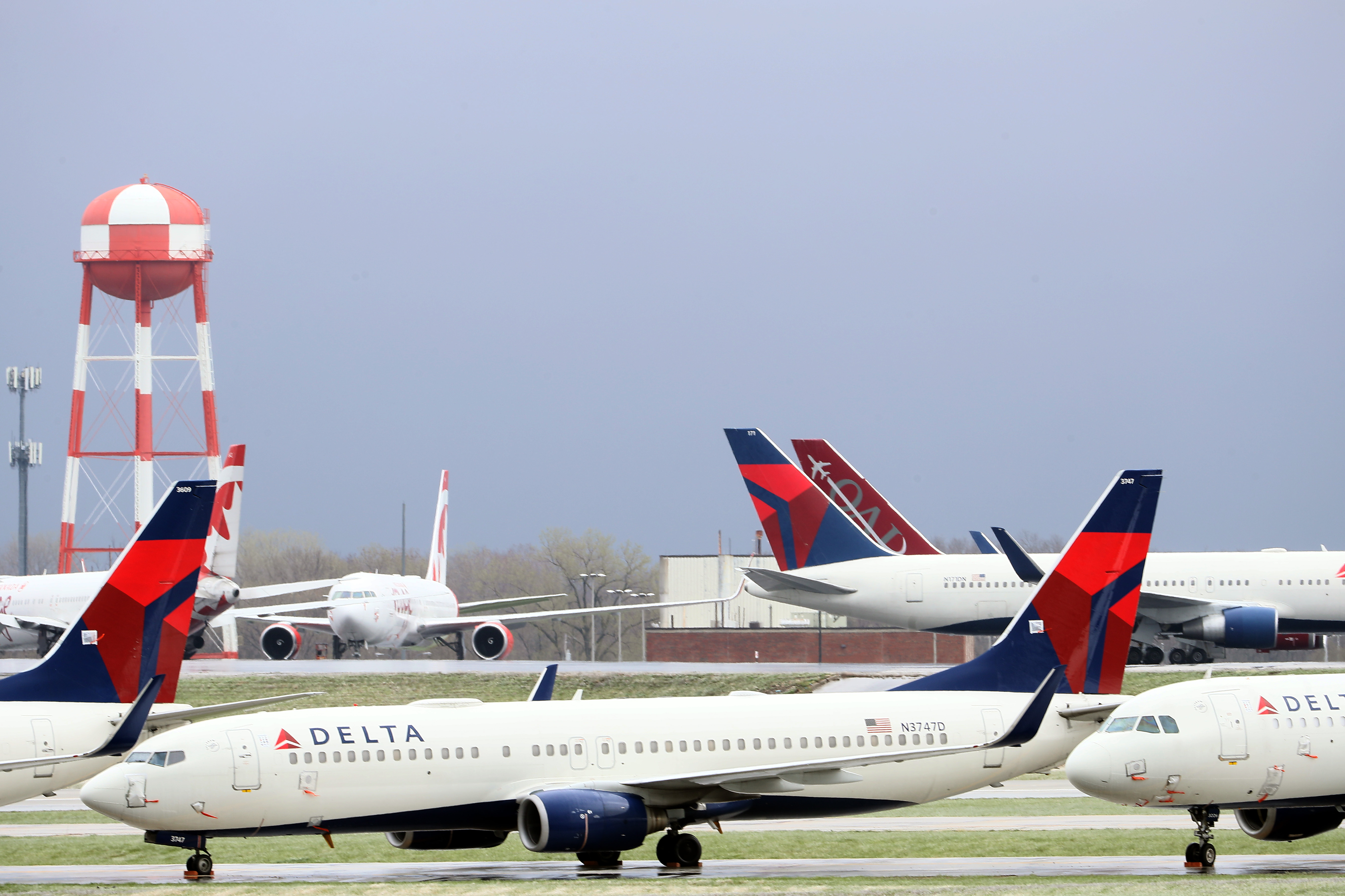 KANSAS CITY, MISSOURI - APRIL 03: Planes belonging to Delta Air Lines sit idle at Kansas City International Airport on April 03, 2020 in Kansas City, Missouri. U.S. carriers reported an enormous drop in bookings amid the spread of the coronavirus and are waiting for a government bailout to fight the impact. Delta lost almost $2 billion in March and parked half of its fleet in order to save money. (Photo by Jamie Squire/Getty Images)