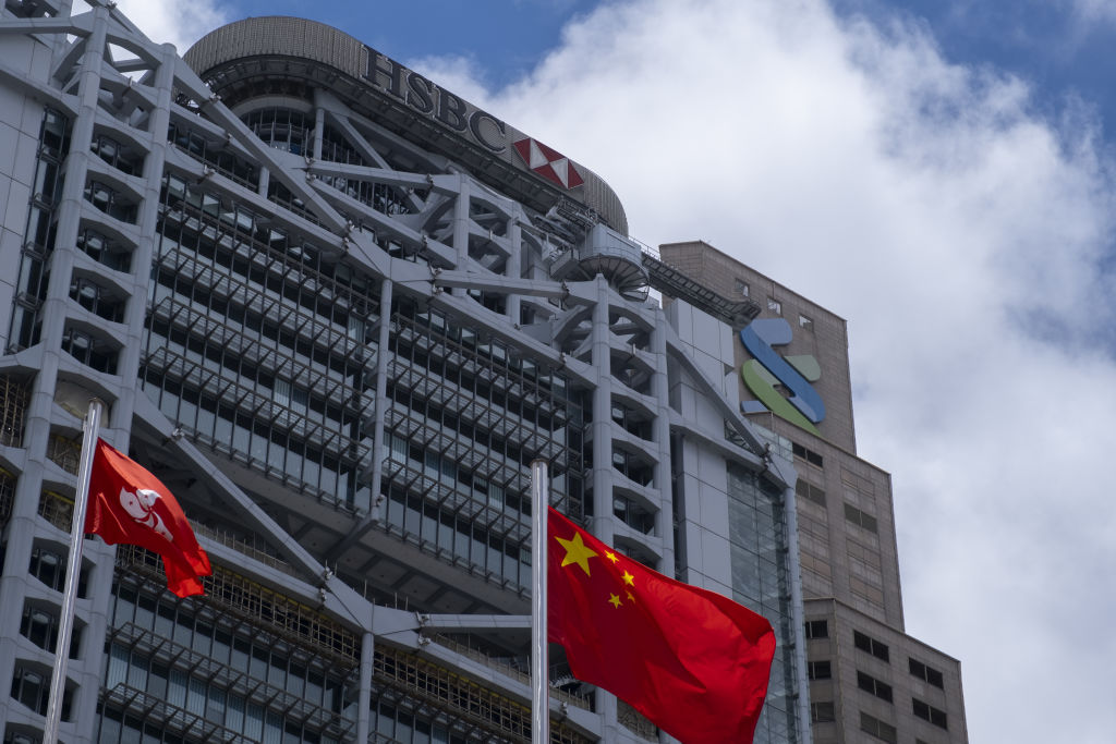 The flags of China and the Hong Kong Special Administrative Region (HKSAR) fly near the HSBC Holdings Plc building, left, and the Standard Chartered Plc building in Hong Kong, China, on Thursday, June 4, 2020. Roy Liu—Bloomberg/Getty Images