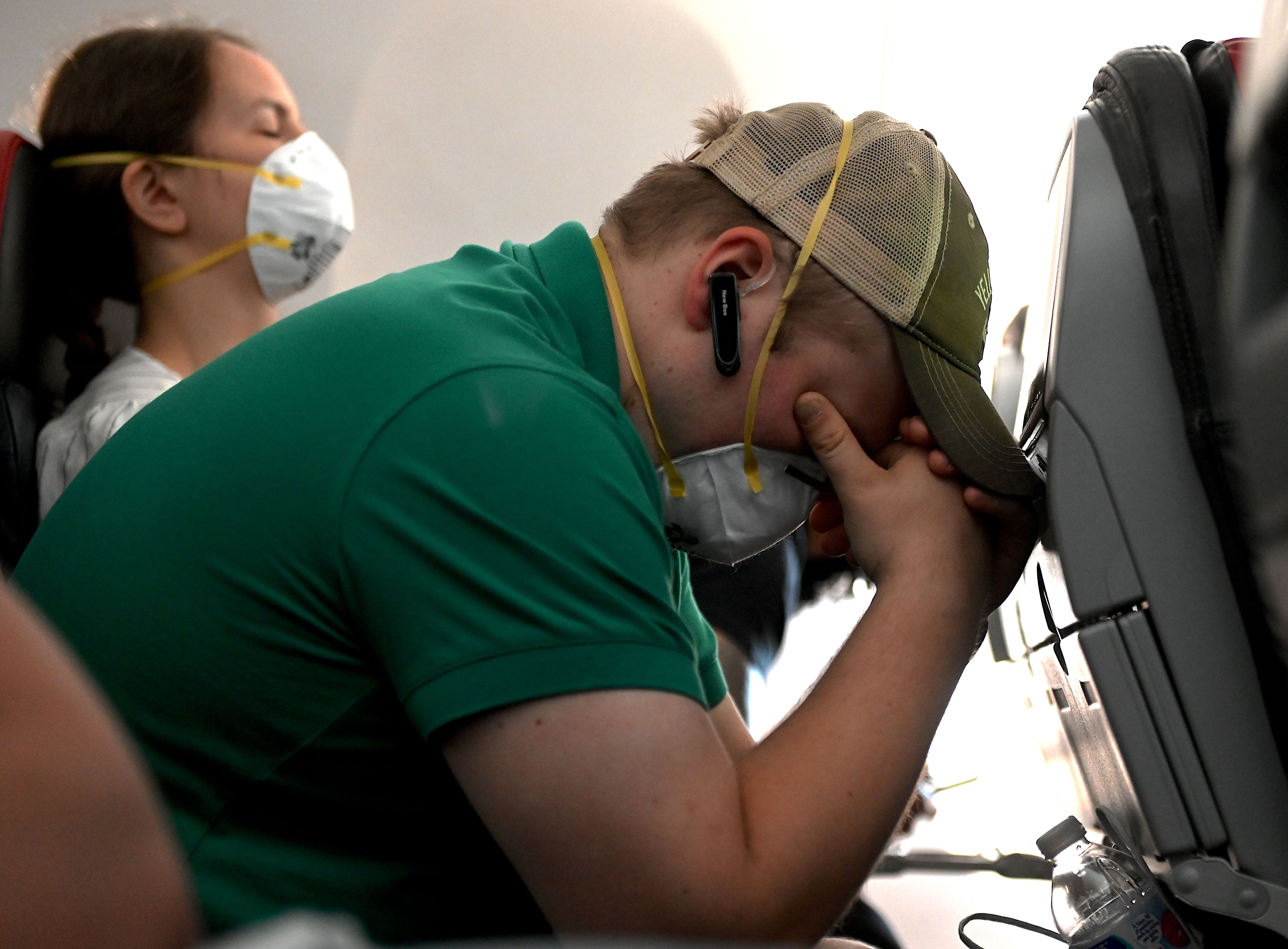 Passengers wear facemasks as they fly on an American Airlines flight to Dallas, Texas on July 2, 2020. - The United States posted a record 53,000 new coronavirus cases as the deadly pandemic accelerated across the Americas. (Photo by ANDREW CABALLERO-REYNOLDS / AFP) (Photo by ANDREW CABALLERO-REYNOLDS/AFP via Getty Images)