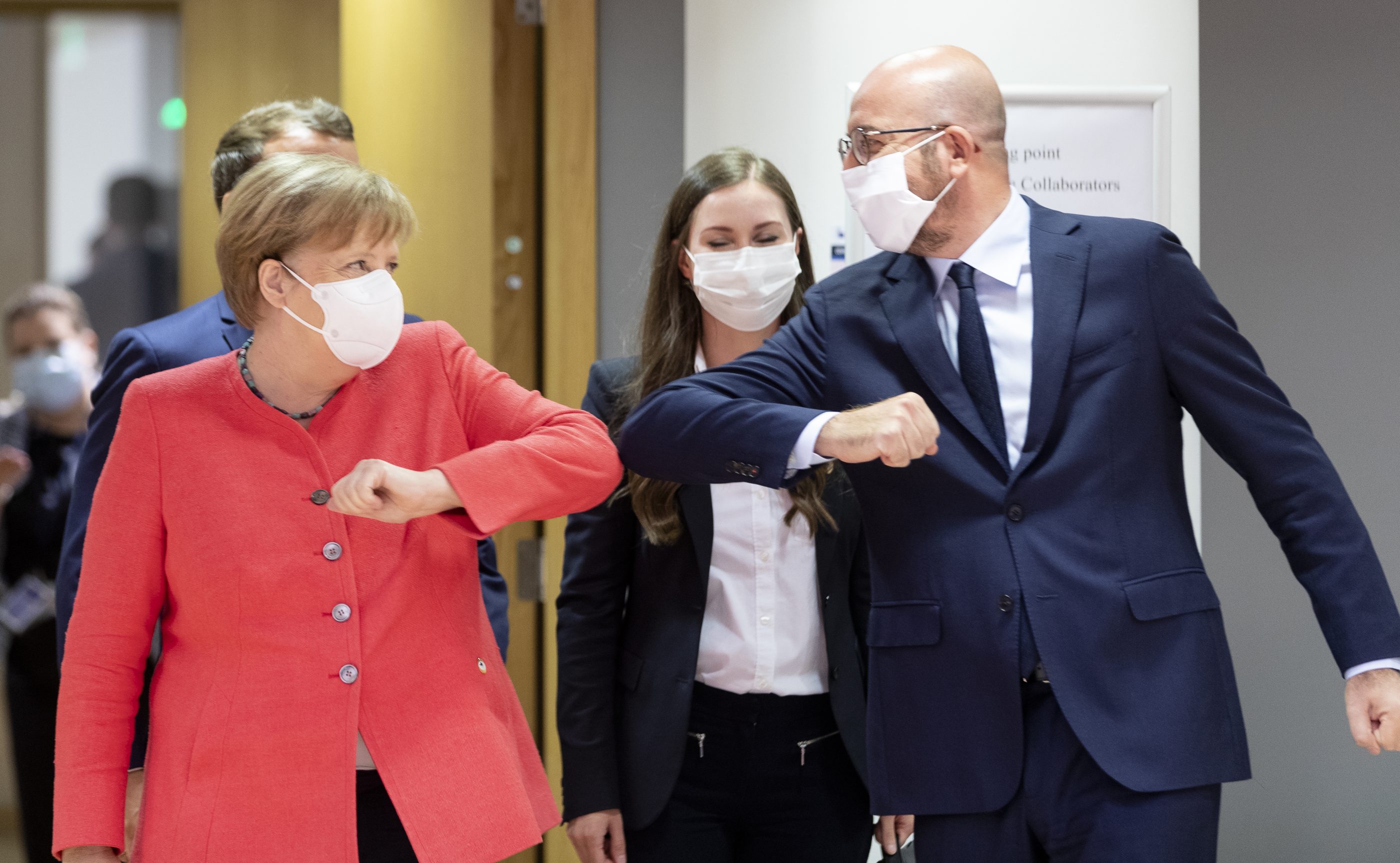 German Chancellor Angela Merkel (left) bumps elbows with Charles Michel, the president of the European Council, during the EU summit in Brussels on July 17. Thierry Monasse—Getty Images
