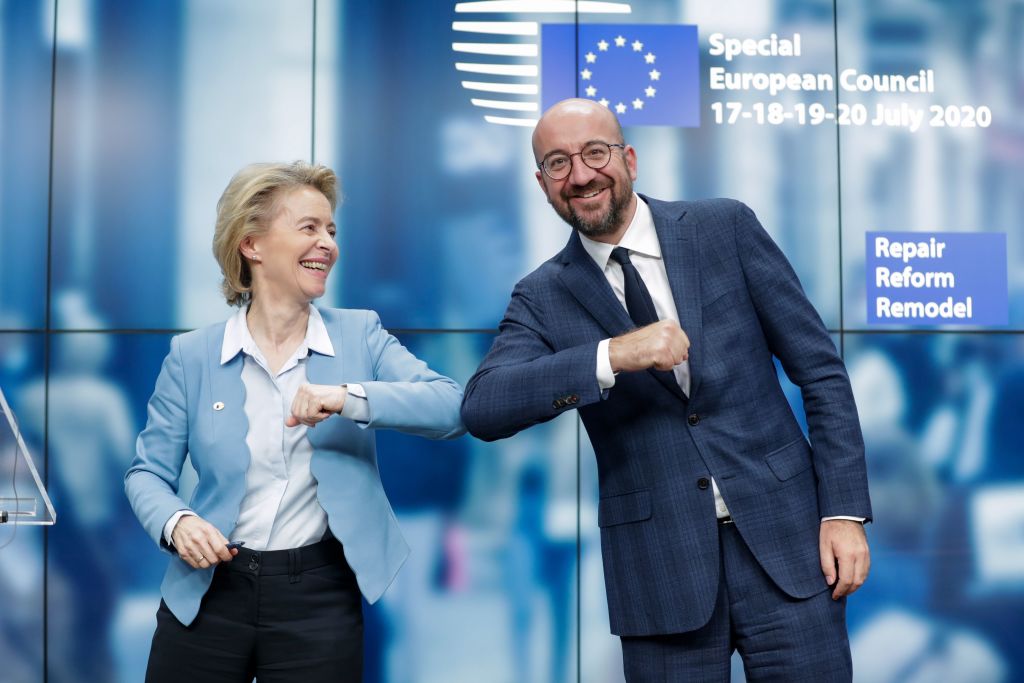 European Commission President Ursula Von Der Leyen (L) and European Council President Charles Michel (R) bump elbows after EU leaders spent four days negotiating a landmark economic recovery package.
(Photo by STEPHANIE LECOCQ/POOL/AFP via Getty Images)