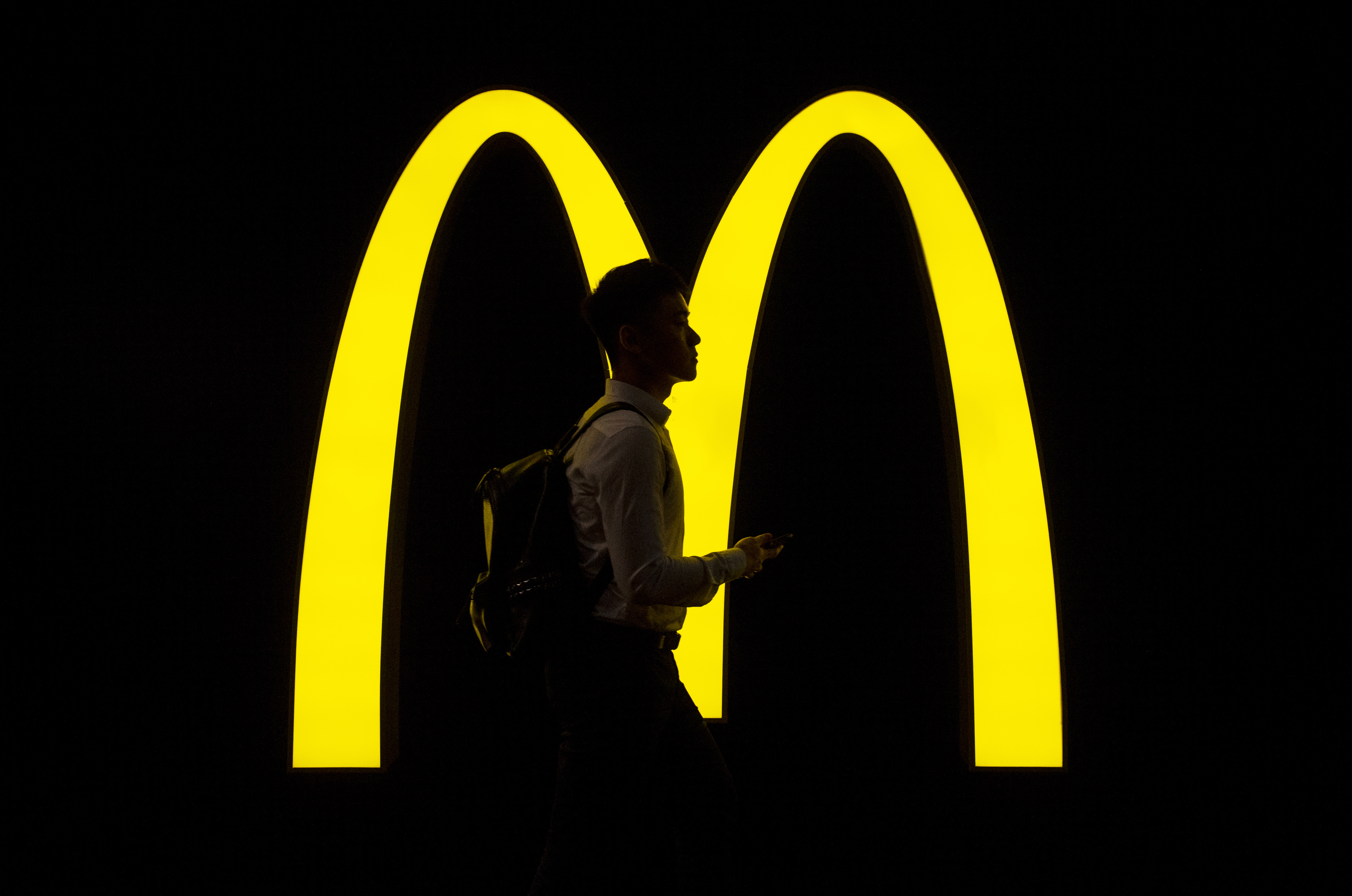 HONG KONG, CHINA - 2020/07/25: A pedestrian walks past an American fast-food hamburger restaurant chain McDonald's logo seen in Hong Kong. (Photo by Budrul Chukrut/SOPA Images/LightRocket via Getty Images)