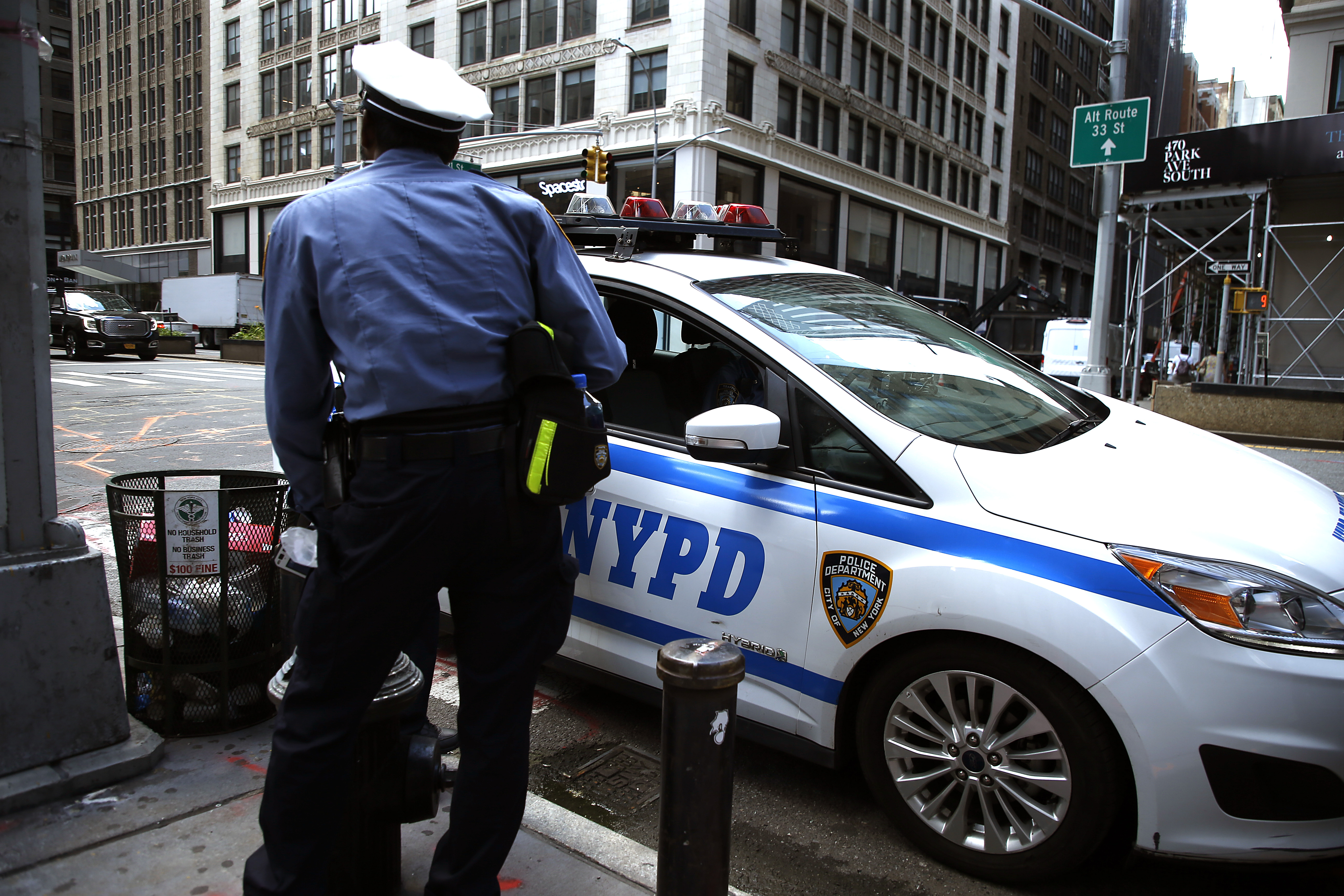 NEW YORK, NEW YORK- JULY 14: A traffic officer stands next to a police car as the city moves into Phase 3 of re-opening following restrictions imposed to curb the coronavirus pandemic on July 14, 2020 in New York City. Phase 3 permits the reopening of nail and tanning salons, tattoo parlors, spas and massages, dog runs and numerous other outdoor activities. Phase 3 is the third of four-phased stages designated by the state.  ( John Lamparski—Getty Images)