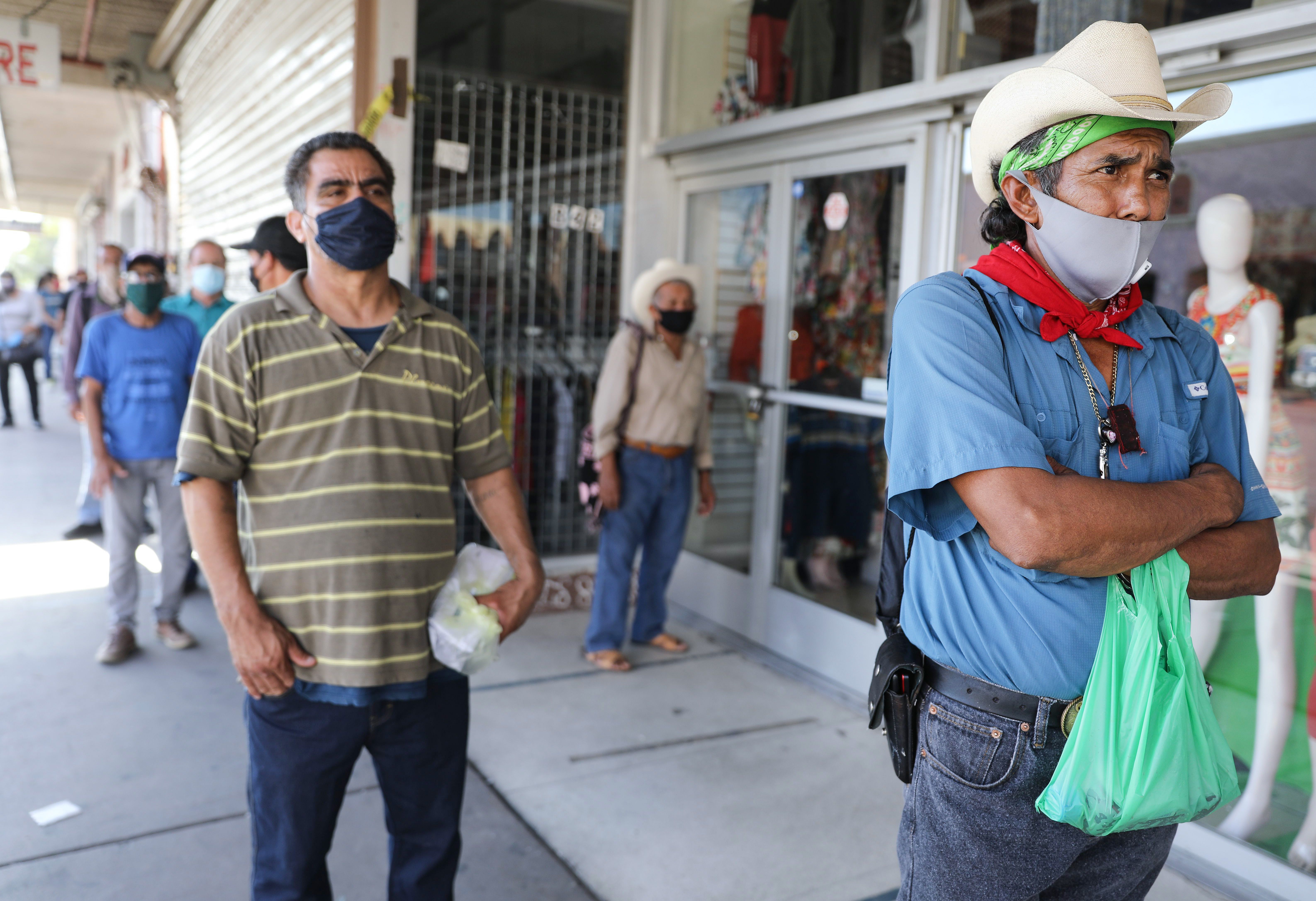 CALEXICO, CALIFORNIA Workers wait in a socially distanced line to enter a bookkeeping shop in order to fill out unemployment forms. Mario Tama—Getty Images