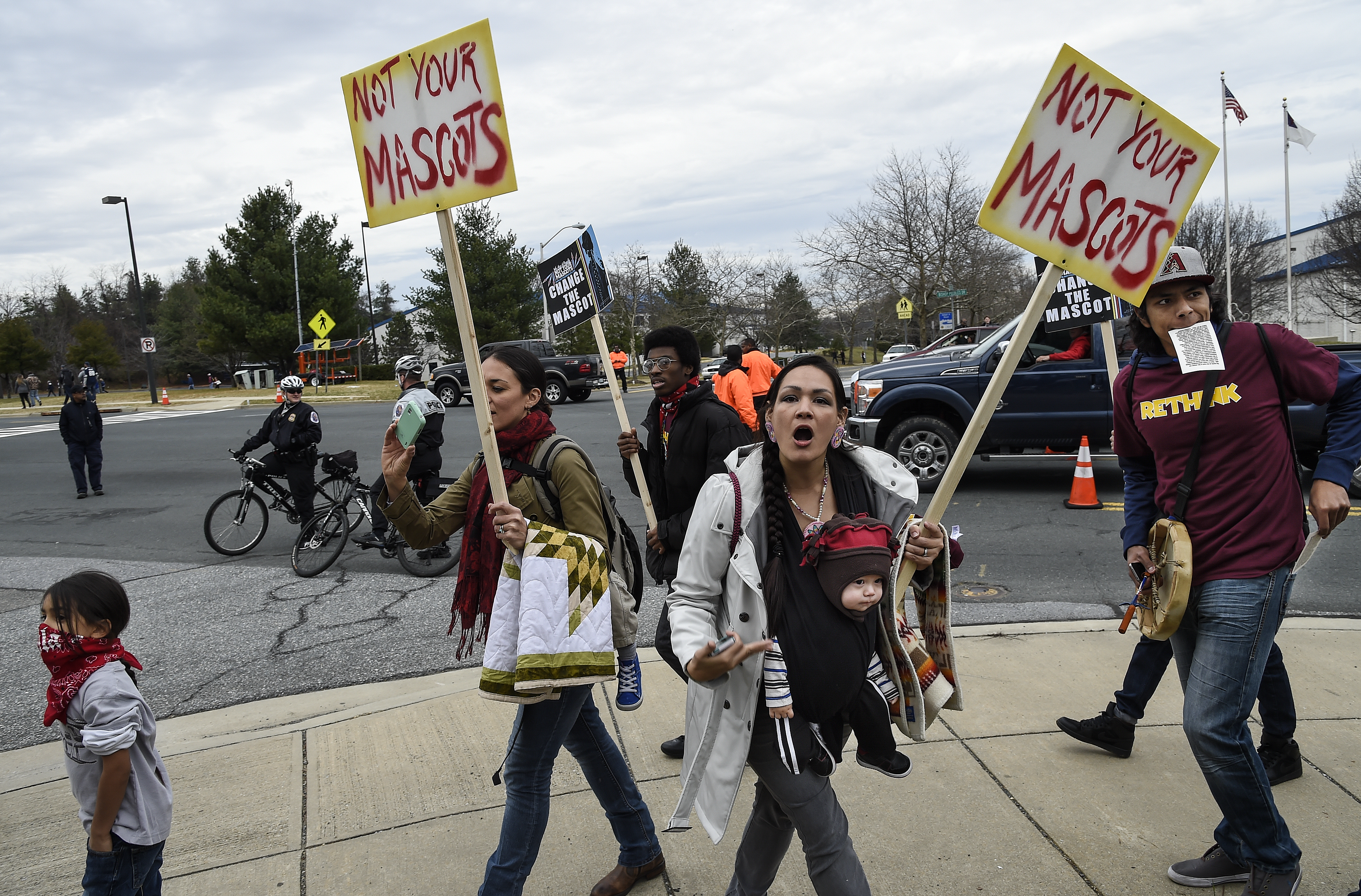 "We are people, not your mascot," shouts Adrianne Plenty Holes in 2014, as she points to her baby Yamni Plenty Holes, 11 months, while participating in a protest of the name and logo of the Washington Football team. Toni L. Sandys/The Washington Post via Getty Images