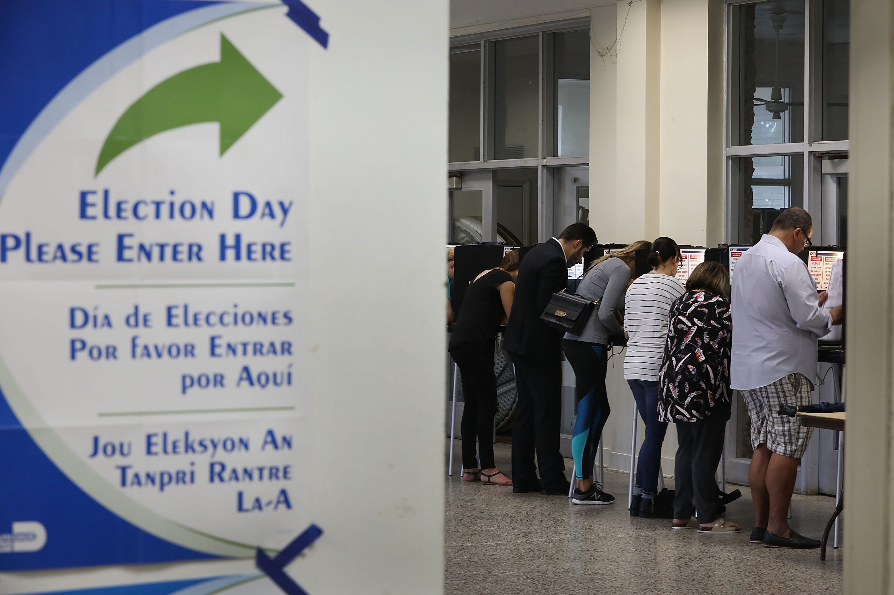 Voters fill out their ballots as they cast their vote at a polling station setup in Legion Park for the mid-term election on November 06, 2018 in Miami, Florida. Joe Raedle/Getty Images