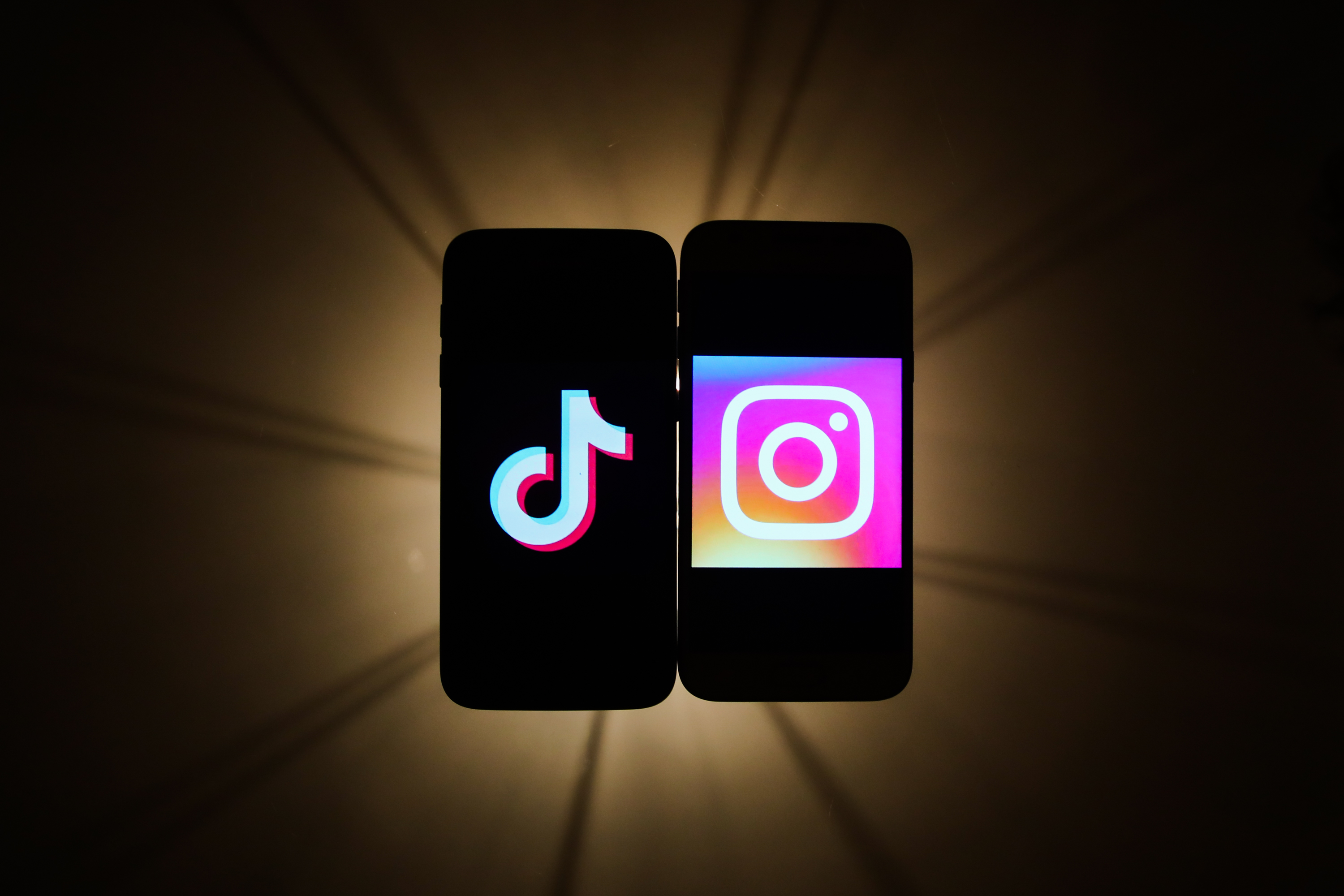 TikTok and Instagram logos are seen displayed on a phone screens in this illustration photo taken in Krakow, Poland on November 14, 2019.  