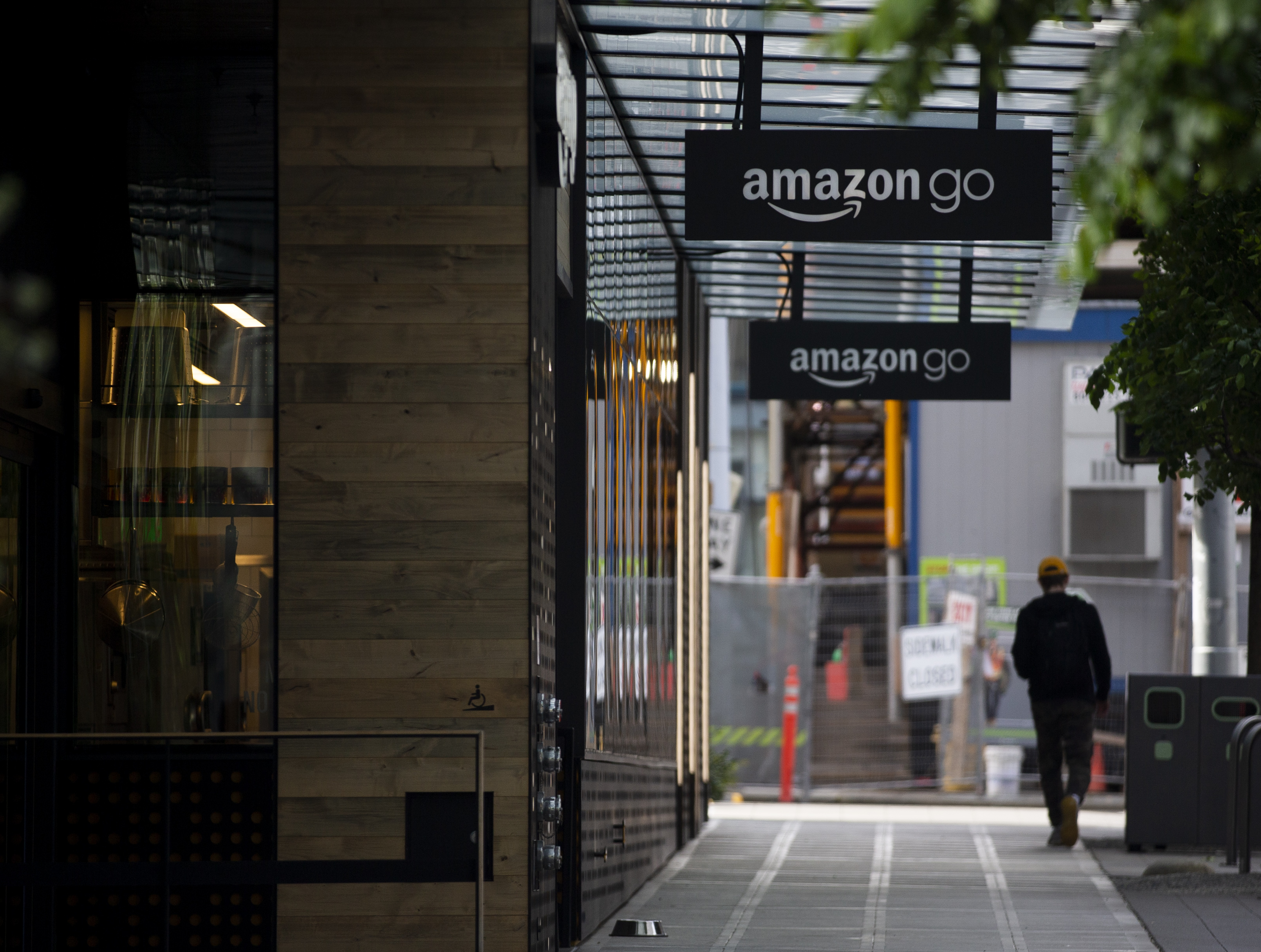 SEATTLE, WA - APRIL 30: A person walks by an Amazon Go store at the downtown Amazon campus on April 30, 2020 in Seattle, Washington. Amazon recorded sales of $75.4 billion in the first three months of the year as many consumers increased their online purchases, up 26% over last year, but with net income for the same period falling nearly 31% due to costs of managing the coronavirus pandemic. (Photo by Lindsey Wasson/Getty Images)