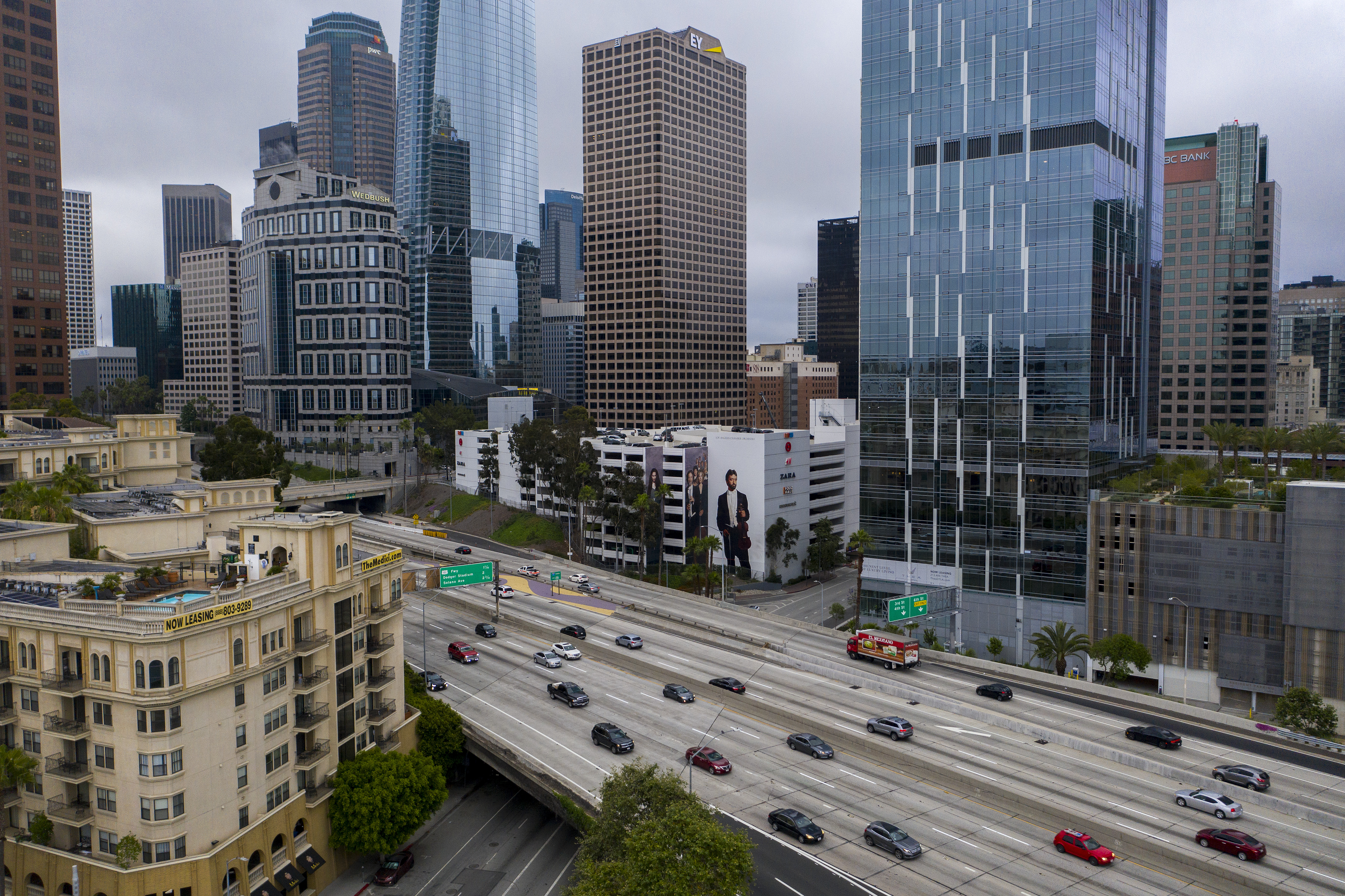 LOS ANGELES, CA - MAY 18: An aerial view shows gradually increasing morning traffic along the Interstate 110 freeway as the coronavirus (COVID-19) pandemic continues, in Los Angeles, California on May 18, 2020. As many people become increasingly eager to return to driving, and as some state and city restrictions are being eased, some drivers are going faster. After a steep drop in deaths in March, when the citys stay-at-home order left left roadways looking nearly deserted, traffic deaths in Los Angeles are now surging back to pre-pandemic levels.