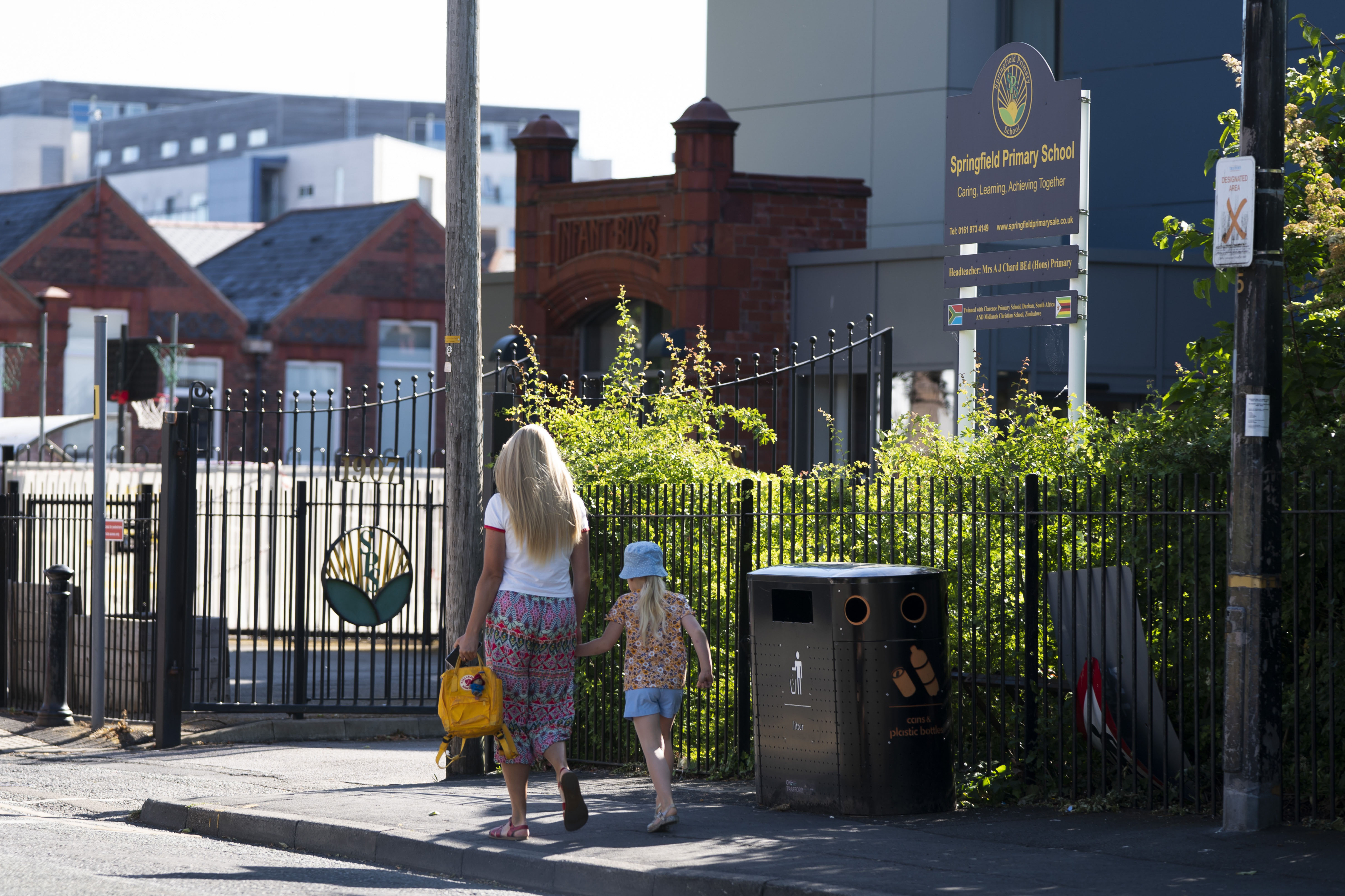 MANCHESTER, June 2, 2020 -- A woman takes a child to Springfield Primary School in Sale in Greater Manchester, Britain on June 1, 2020. As most primary schools in England reopened to more pupils on Monday, a survey from an authoritative education body suggested that schools expect half of parents would like to keep their children at home rather than send them back to school. (Photo by Jon Super/Xinhua via Getty) (Xinhua/Jon Super via Getty Images)