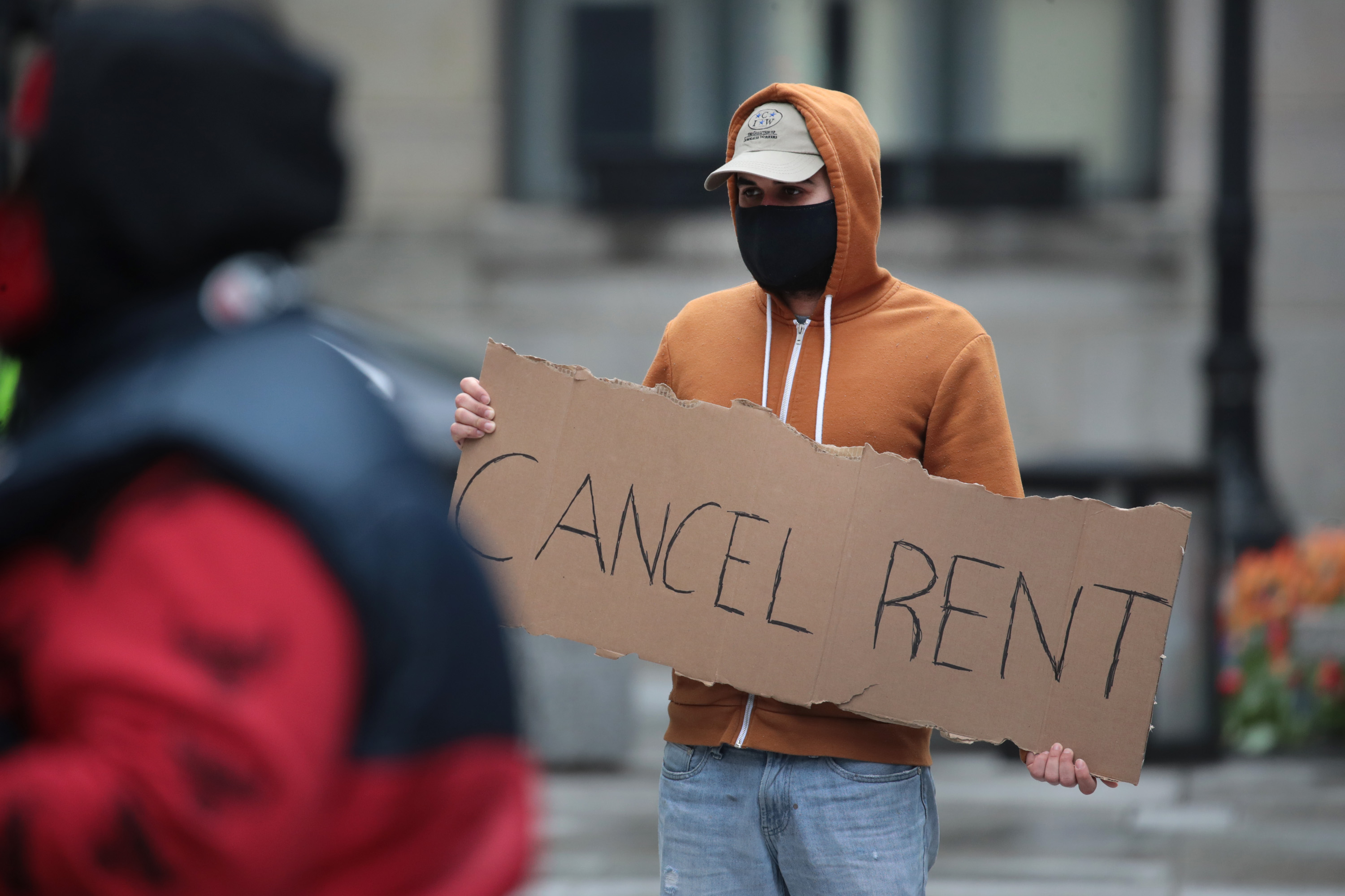CHICAGO, ILLINOIS  - APRIL 30: A demonstrator calls on the governor to suspend rent and mortgage payments to help those who have lost their income due to the coronavirus during a protest on April 30, 2020 in Chicago, Illinois.Scott Olson/Getty Images