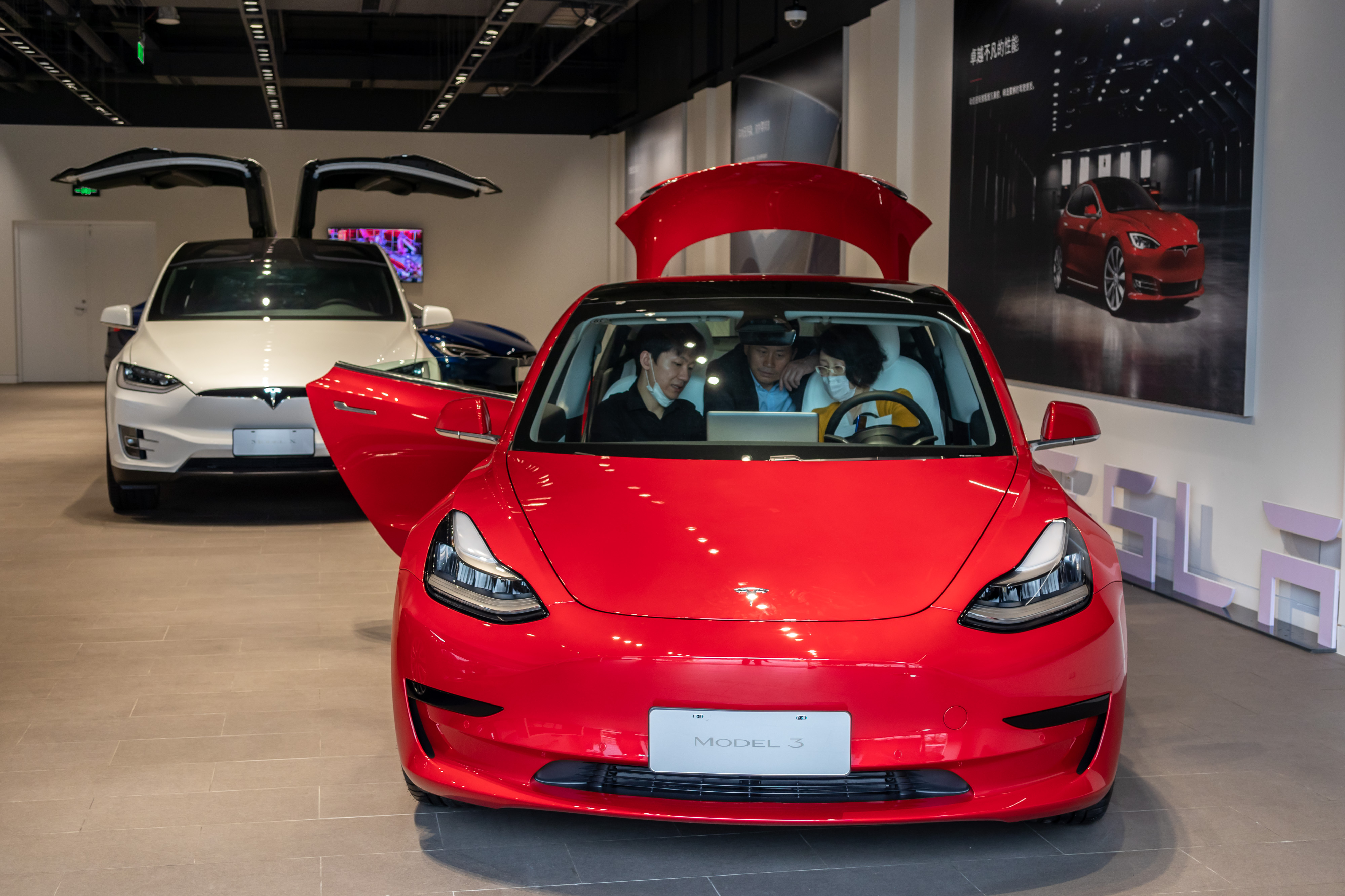 SHANGHAI, CHINA - MAY 09: People sit in a Tesla Model 3 car at the first Tesla Center in Shanghai on May 9, 2020 in Shanghai, China. Wang Gang—VCG/Getty Images