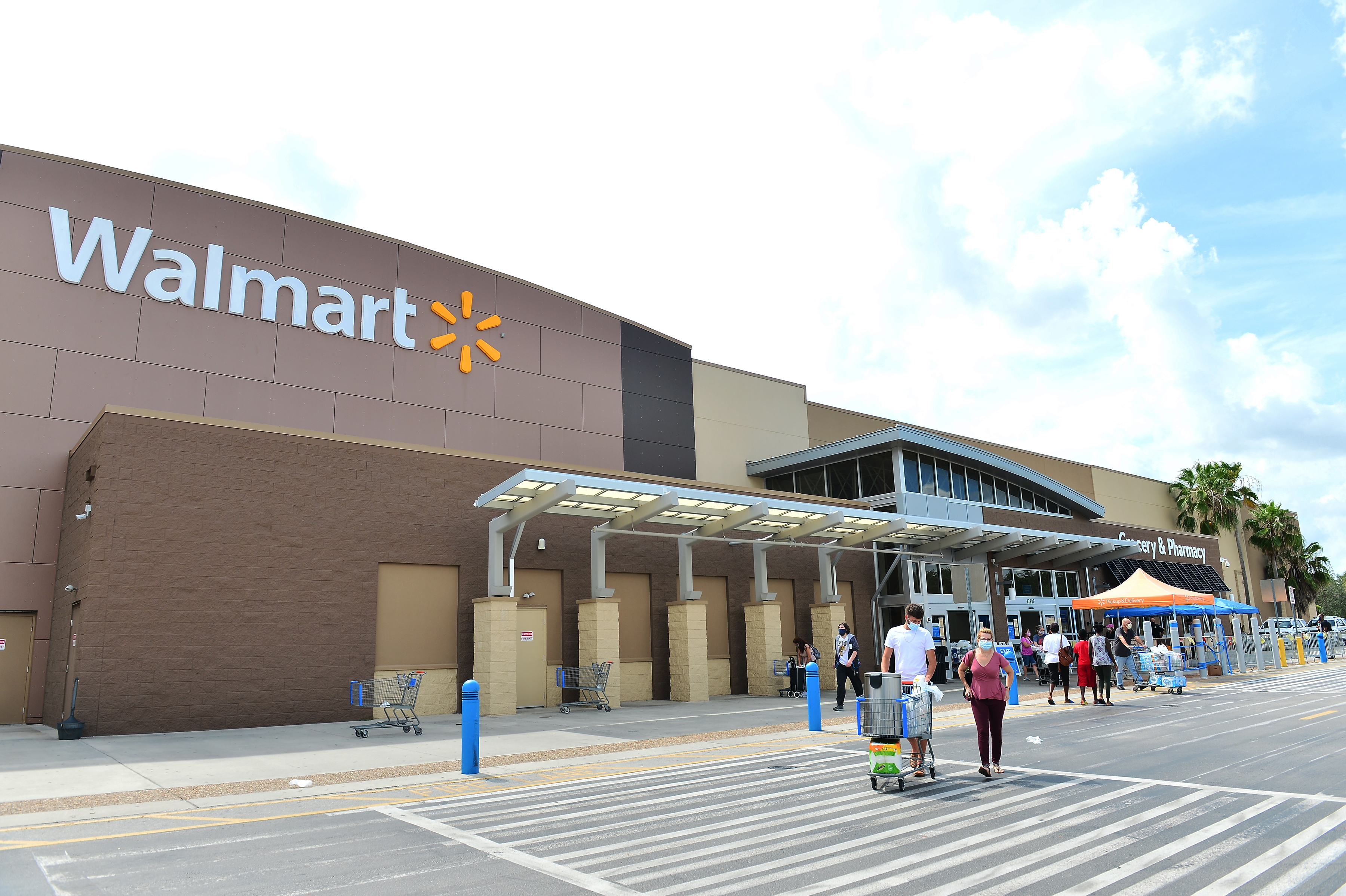 PEMBROKE PINES, FLORIDA - JULY 16: Customers wearing face masks leave a Walmart retail store on July 16, 2020 in Pembroke Pines, Florida. (Photo by Johnny Louis/Getty Images)
