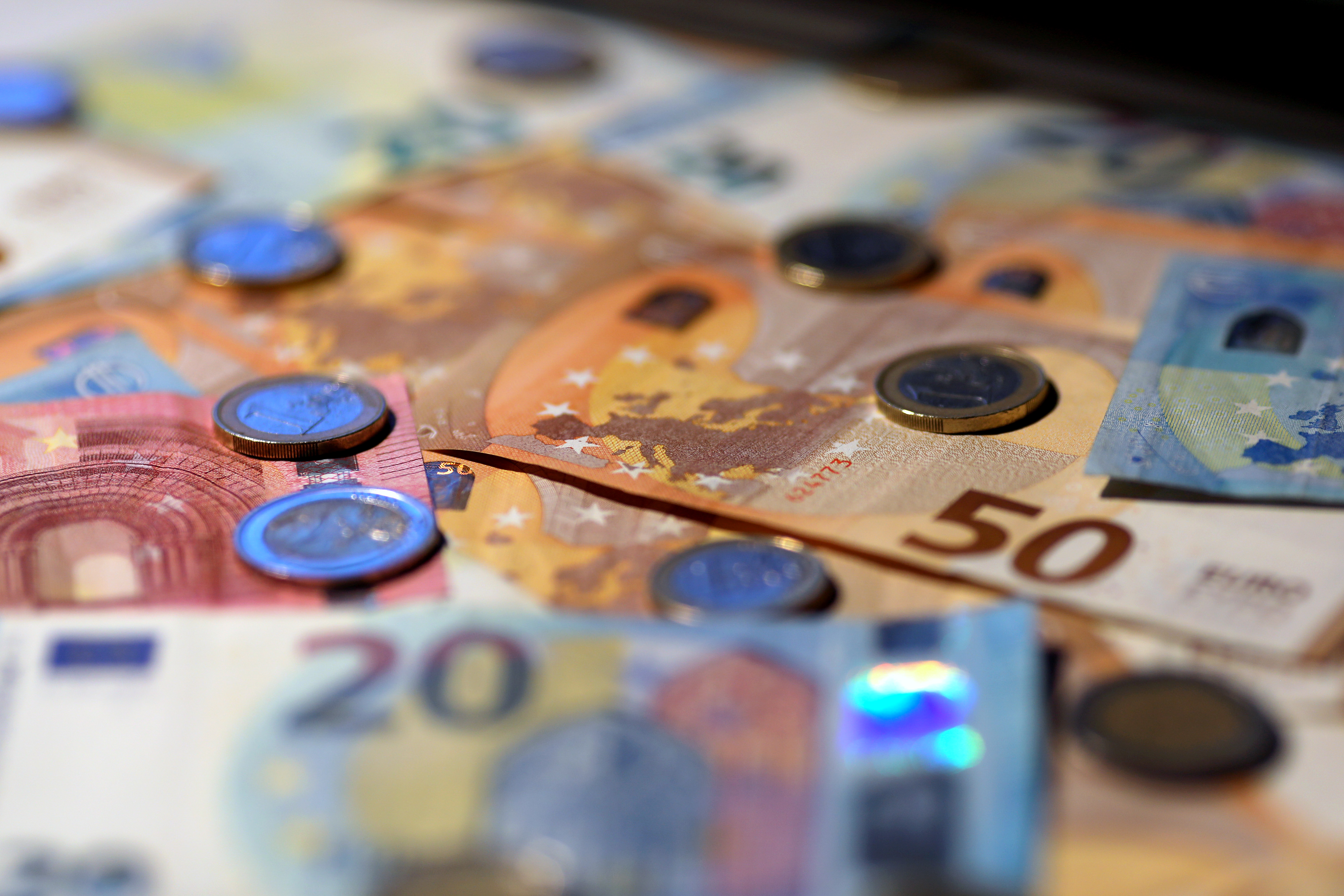 A selection of Euro coins sit on a display of Euro banknotes of varying denominations in this arranged photograph in Rome, Italy, on Tuesday, July 21, 2020. The euro has stayed below $1.15 even after European Union leaders finally agreed on a landmark stimulus package -- yet, this should not be interpreted as a sign of weakness. Photographer: Alessia Pierdomenico/Bloomberg via Getty Images