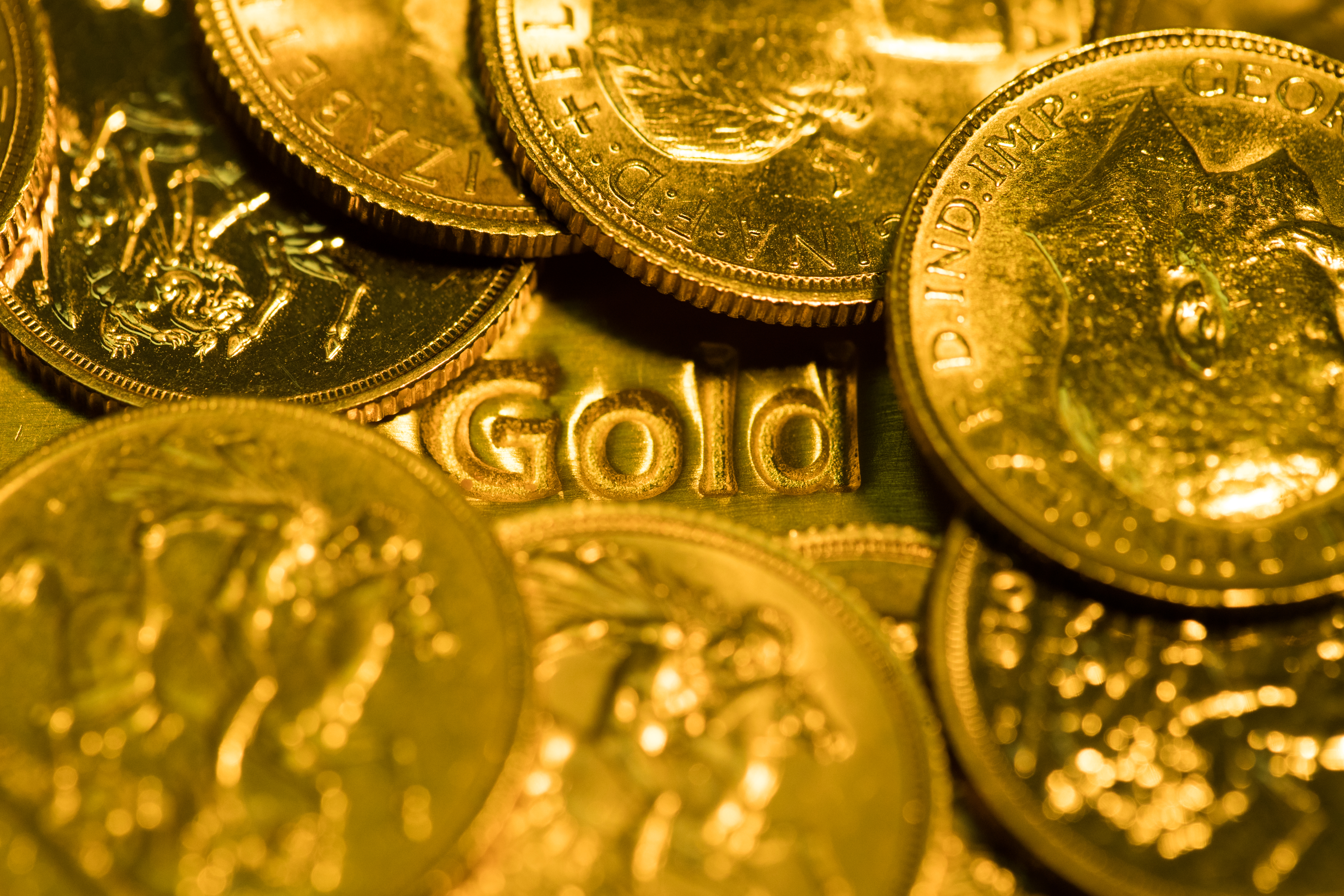 United Kingdom sovereign gold coins sit on a one-kilogram gold bar at Gold Investments Ltd. bullion dealers in this arranged photograph in London, U.K., on Wednesday, July 29, 2020. Gold held its ground after a record-setting rally as investors awaited the outcome of a Federal Reserve meeting amid expectations policy makers will remain dovish, potentially spurring more gains. Photographer: Chris Ratcliffe/Bloomberg via Getty Images