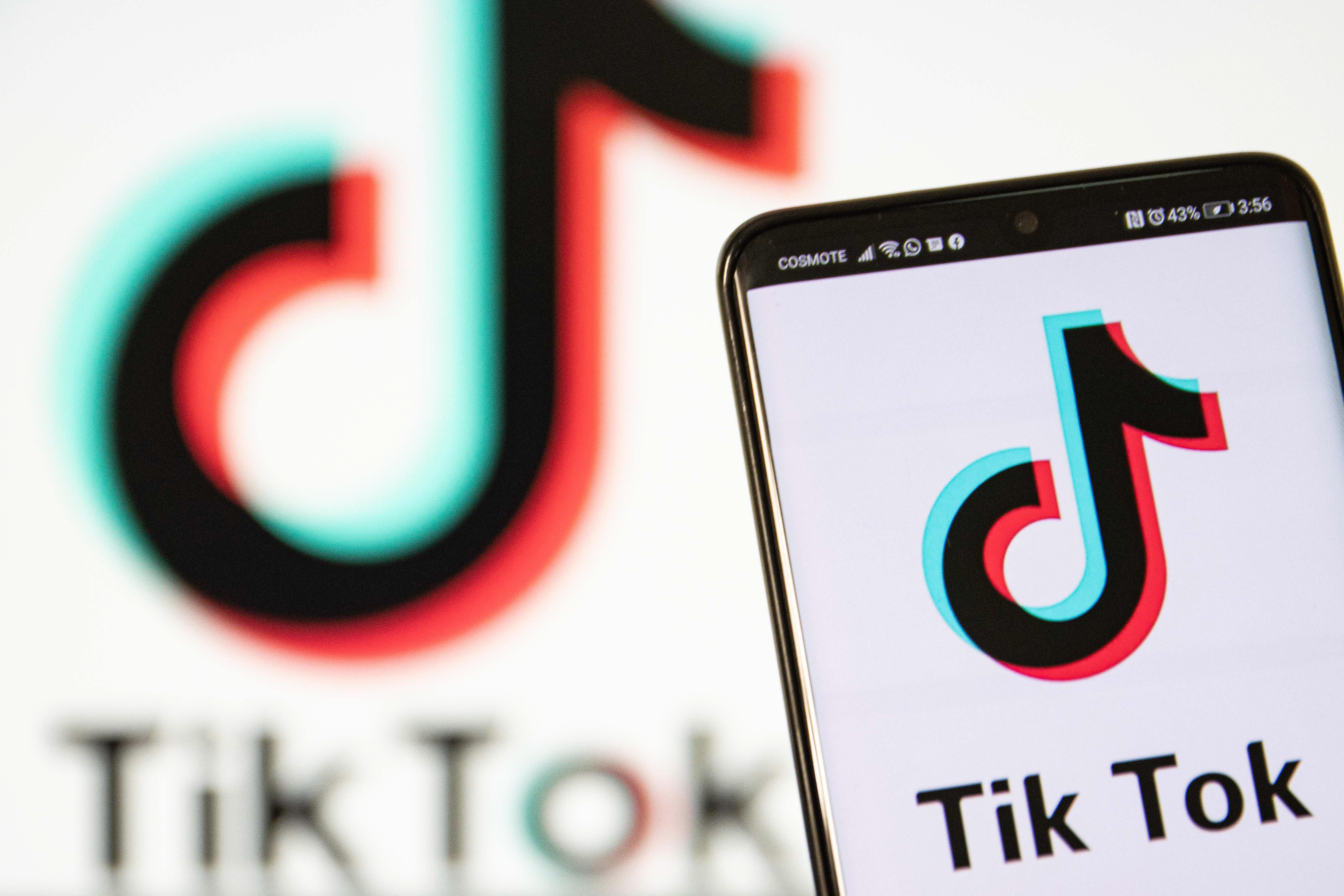 TikTok closeup logo displayed on a phone screen, smartphone and keyboard are seen in this multiple exposure illustration. Tik Tok is a Chinese video-sharing social networking service owned by a Beijing based internet technology company, ByteDance. It is used to create short dance, lip-sync, comedy and talent videos. ByteDance launched TikTok app for iOS and Android in 2017 and earlier in September 2016 Douyin fror the market in China. TikTok became the most downloaded app in the US in October 2018. President of the USA Donald Trump is threatening and planning to ban the popular video sharing app TikTok from the US because of the security risk. Thessaloniki, Greece - August 1, 2020 (Photo by Nicolas Economou/NurPhoto via Getty Images)