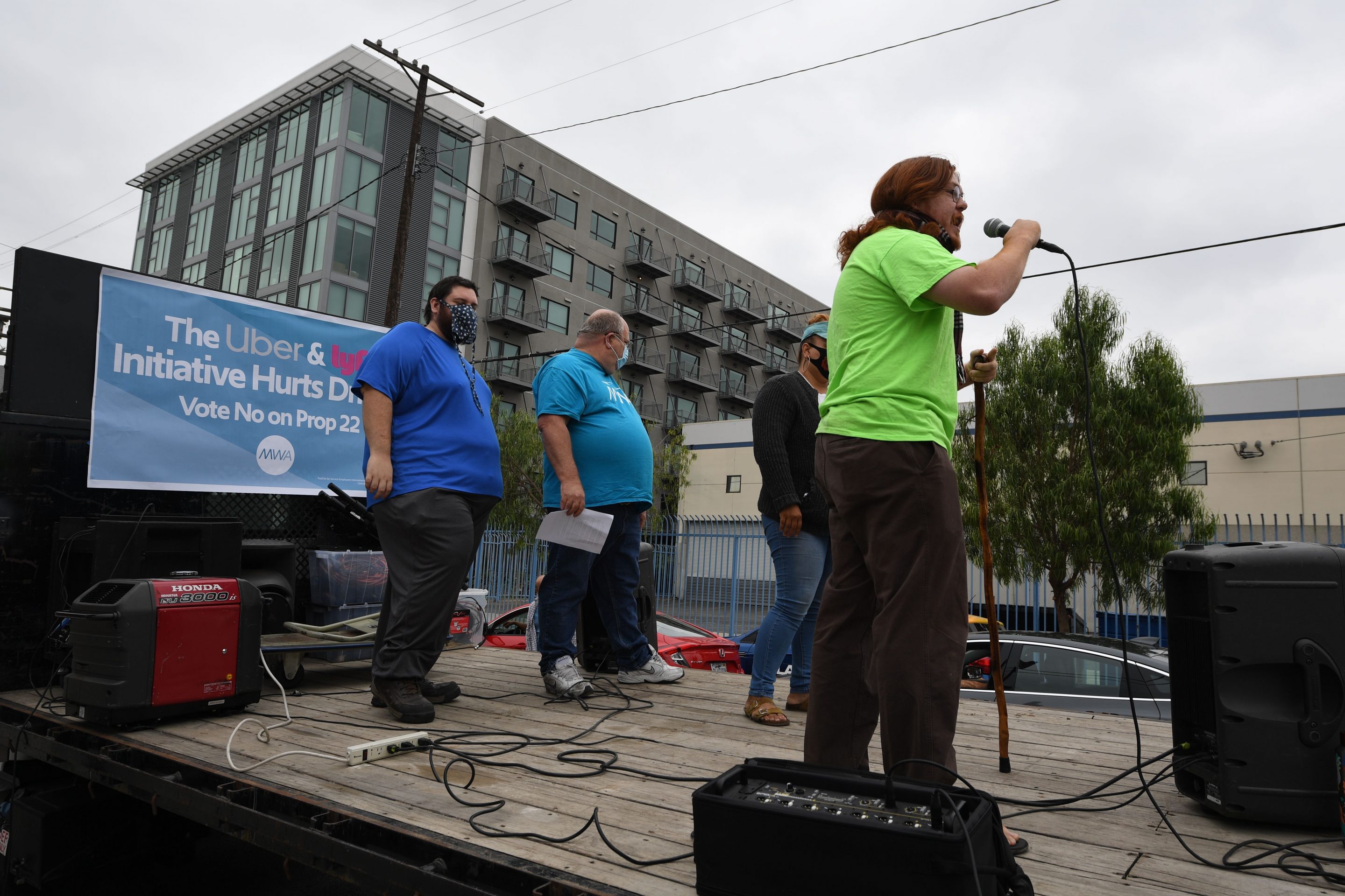 Rideshare drivers demonstrate against rideshare companies Uber and Lyft during a car caravan protest on August 6, 2020 in Los Angeles. - The drivers, organized by the Mobile Workers Alliance and Rideshare Drivers United unions, say Uber and Lyft's are pushing a "deceptive" November ballot initiative, which, if passed, they claim would "rewrite labor law" and turn app-based drivers into independent contractors, exempting companies such as Lyft and Uber from standard wage and hour restrictions. (Photo by Robyn Beck / AFP) (Photo by ROBYN BECK/AFP via Getty Images)