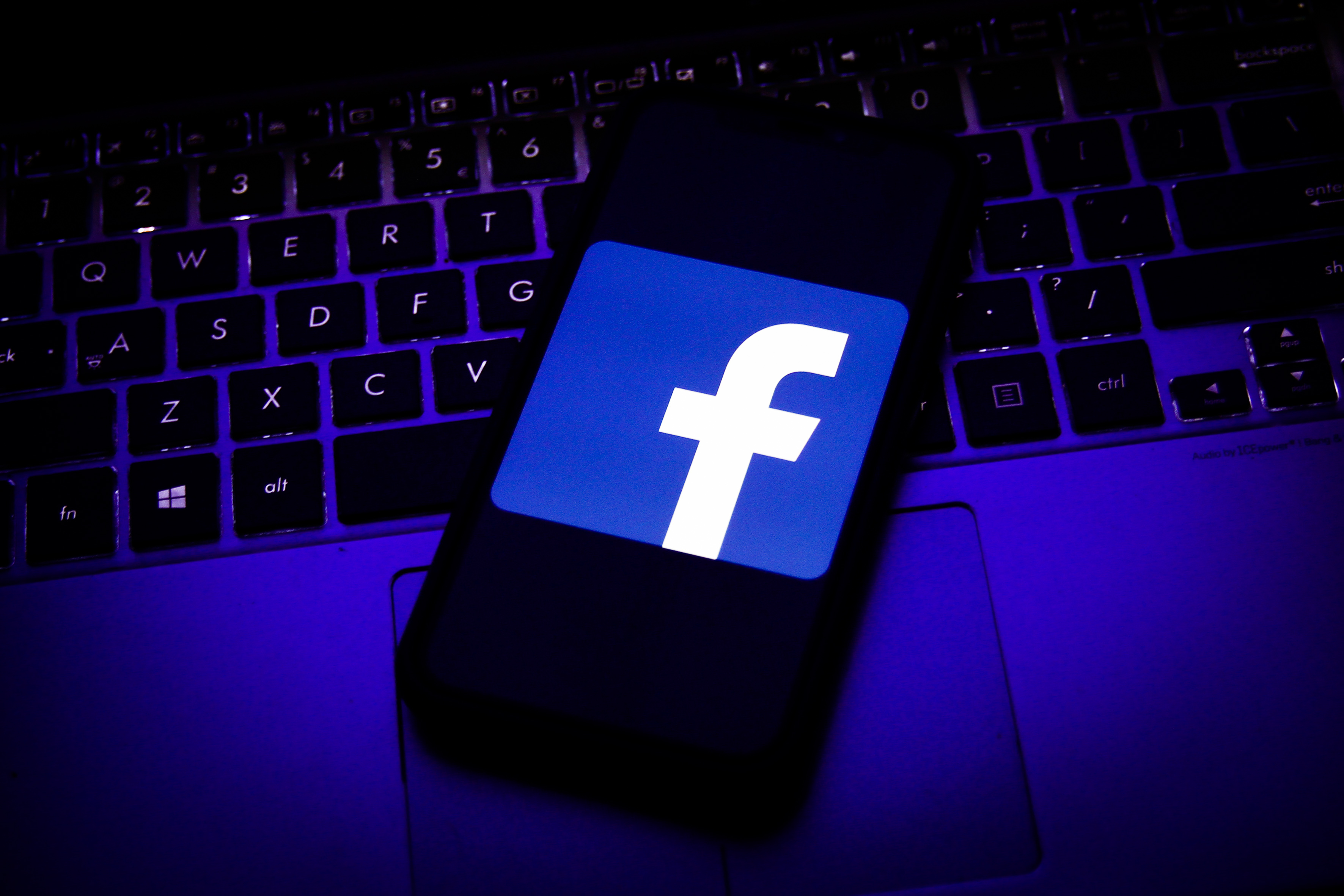 Logo of Facebook displayed on a smartphone screen and keyboard are seen in this illustration photo taken in Krakow, Poland on August 11, 2020.