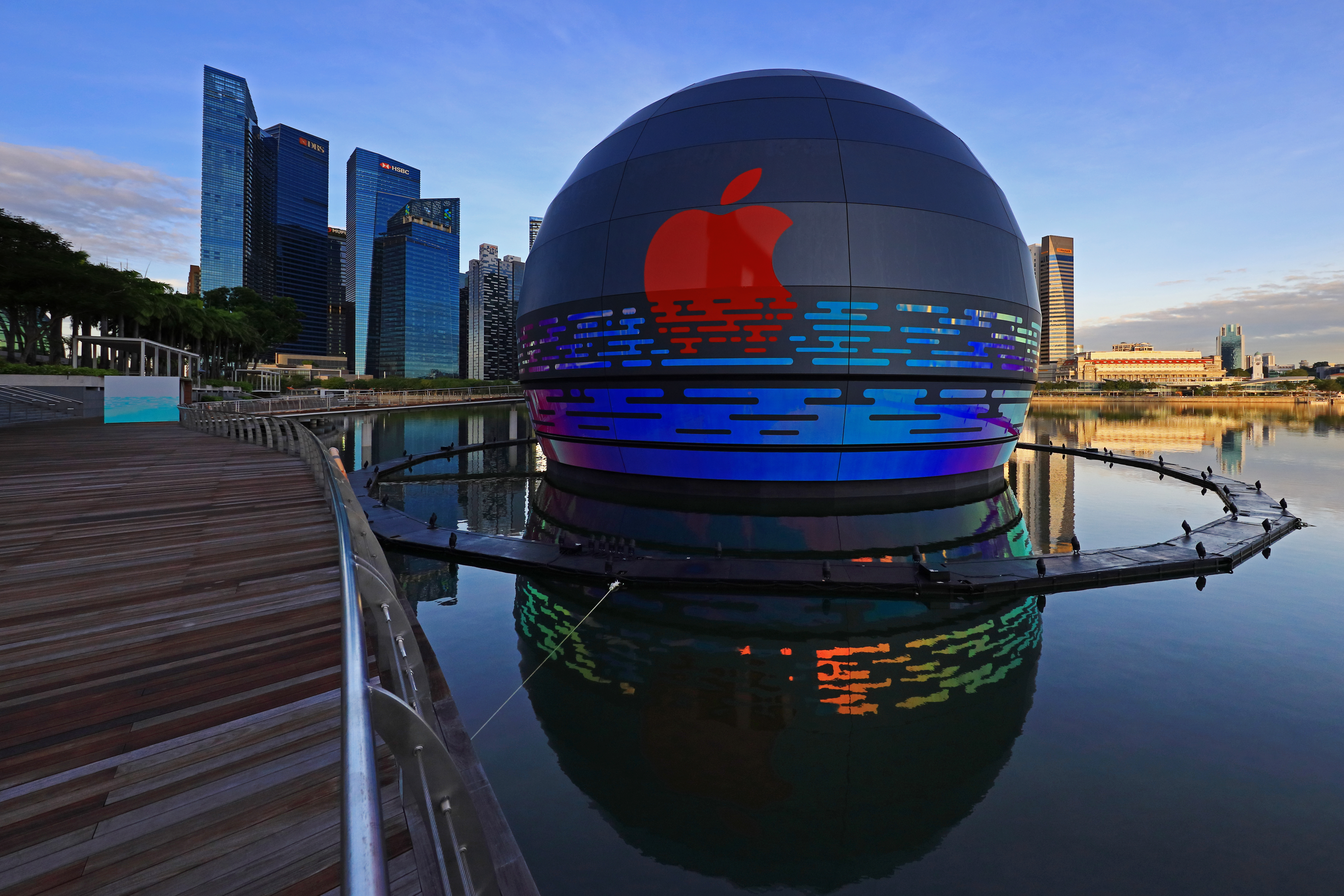 SINGAPORE - AUGUST 26:  A general view of the new Apple flagship store against the city skyline at Marina Bay Sands waterfront on August 26, 2020 in Singapore. The store located in a futuristic giant glass orb is the third Apple store to open in Singapore.  