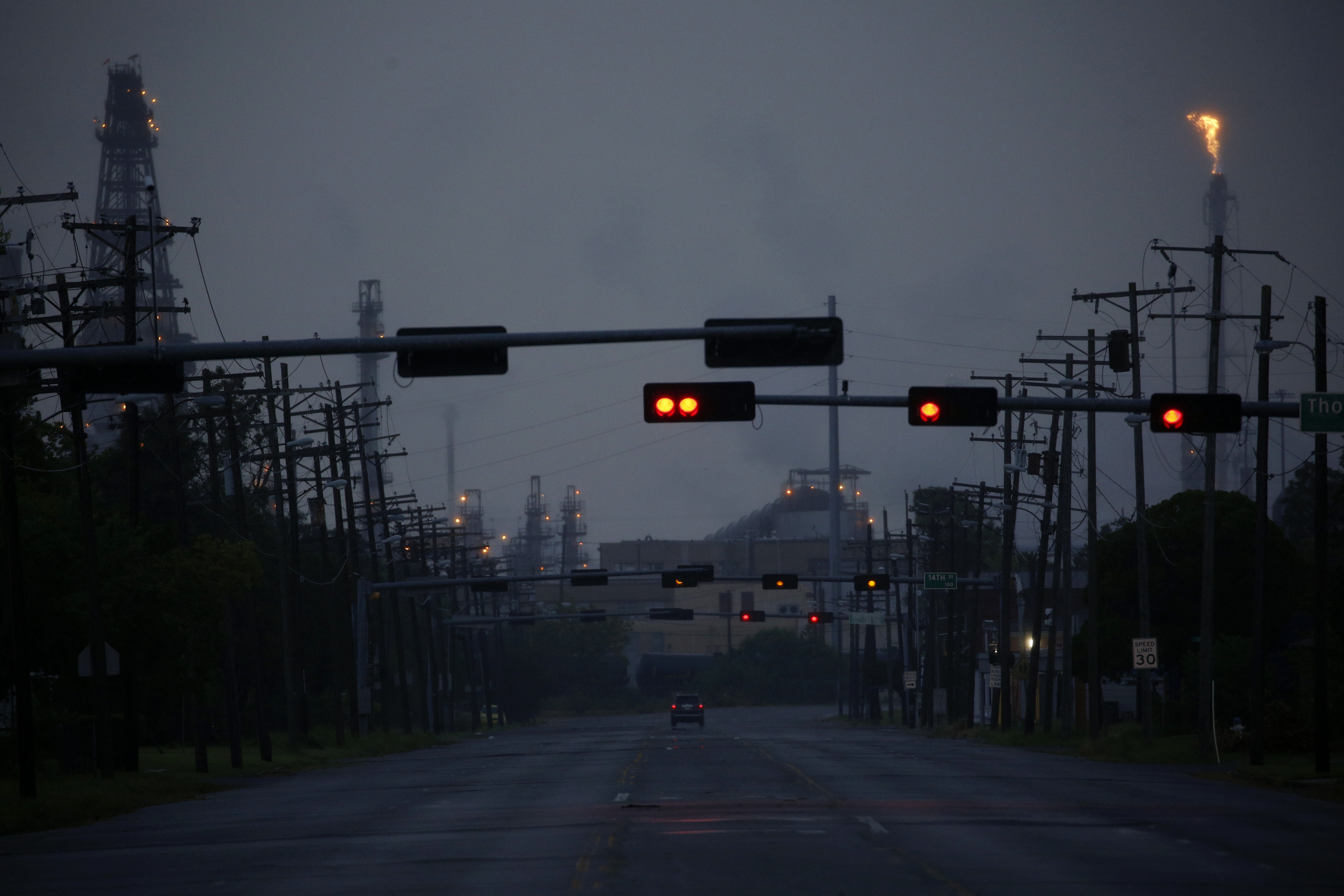 A vehicle travels on an empty road near the Motiva Enterprises LLC Refinery ahead of Hurricane Laura in Port Arthur, Texas, U.S., on Tuesday, Aug. 25, 2020. Hurricane Laura is poised to become a roof-ripping Category 3 storm when it comes ashore along the Texas-Louisiana coast, threatening to inflict as much as $12 billion of damage on the region and potentially shutting 12% of U.S. refining capacity for months. Photographer: Luke Sharrett/Bloomberg via Getty Images