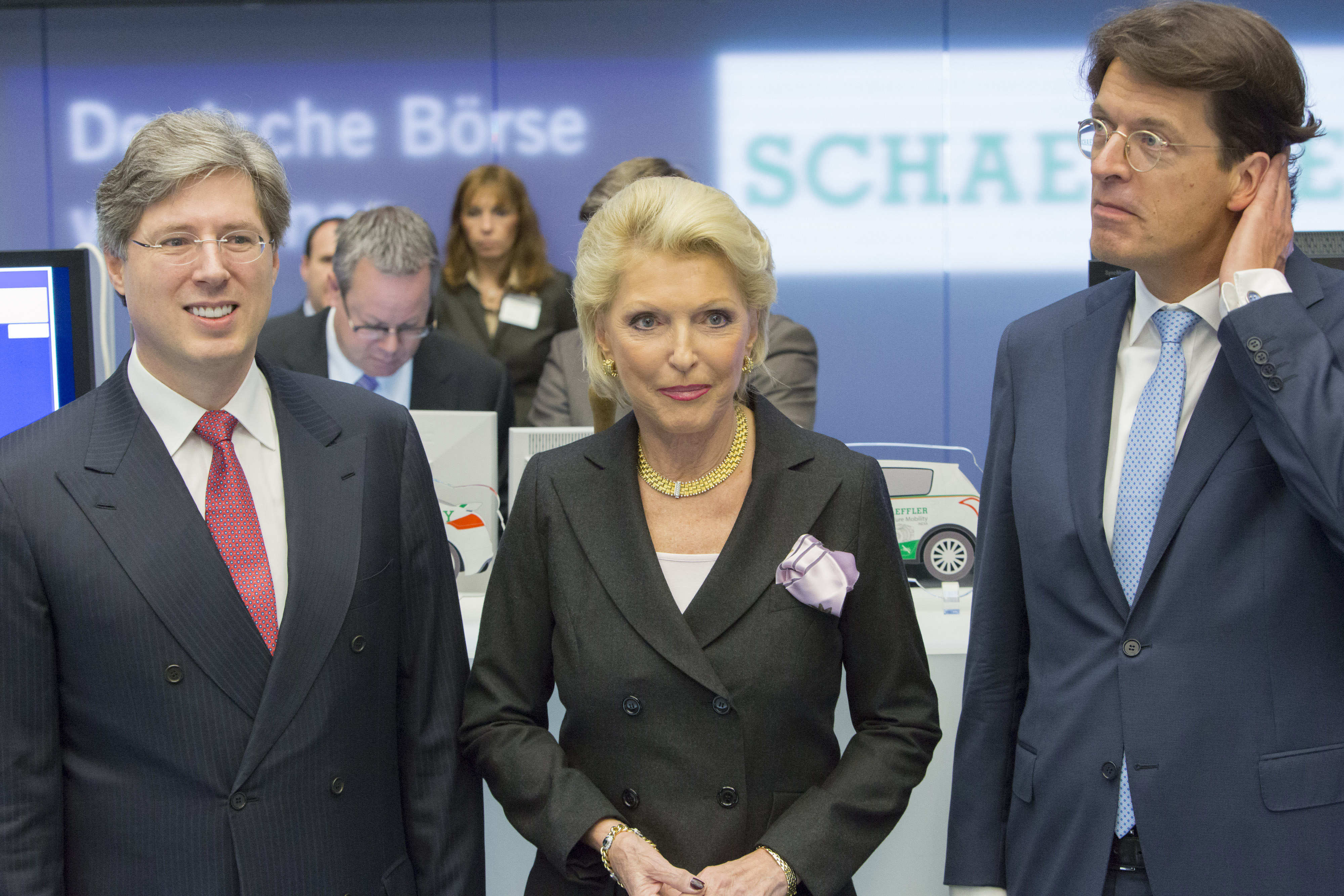 Georg Schaeffler, billionaire and chairman of Schaeffler AG, left, Maria-Elisabeth Schaeffler-Thumann, billionaire and vice-chairwoman of Schaeffler AG, center, and Klaus Rosenfeld, chief executive officer of Schaeffler AG, pose for a photograph inside the Frankfurt Stock Exchange, in Frankfurt, Germany, on Friday, Oct. 9, 2015. Schaeffler cut the size of its planned initial public offering by more than half and now seeks to raise only about 975 million euros ($1.1 billion), after the auto industry was buffeted by the Volkswagen AG emissions-testing scandal. Photographer: Martin Leissl/Bloomberg via Getty Images