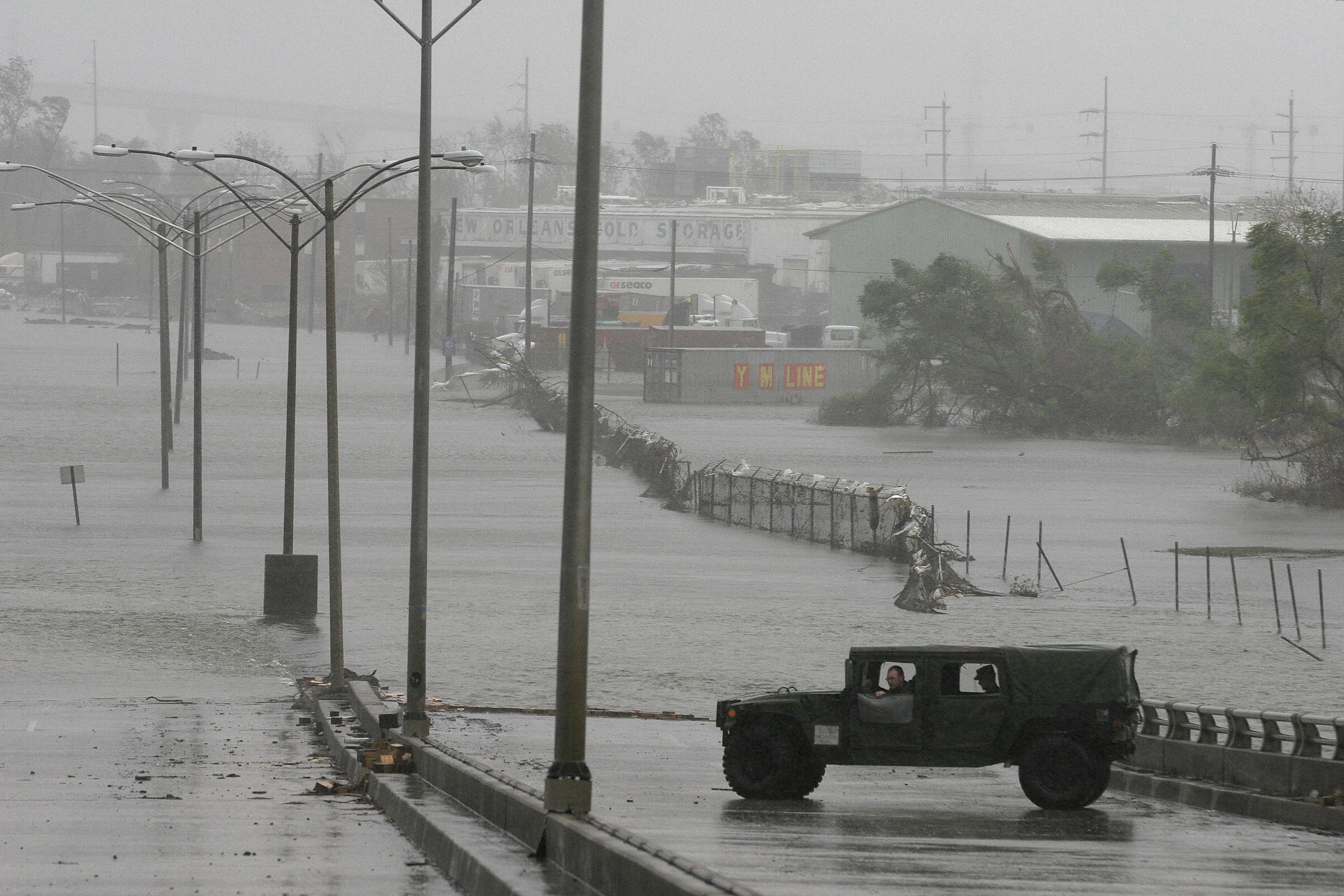 A military vehicle surveys the situation on Sept. 23, 2005 as water floods back into streets of the Ninth Ward after surge waters from Hurricane Rita topped over a patched section of the levee along the Industrial Canal, which had given way during Hurricane Katrina in New Orleans.