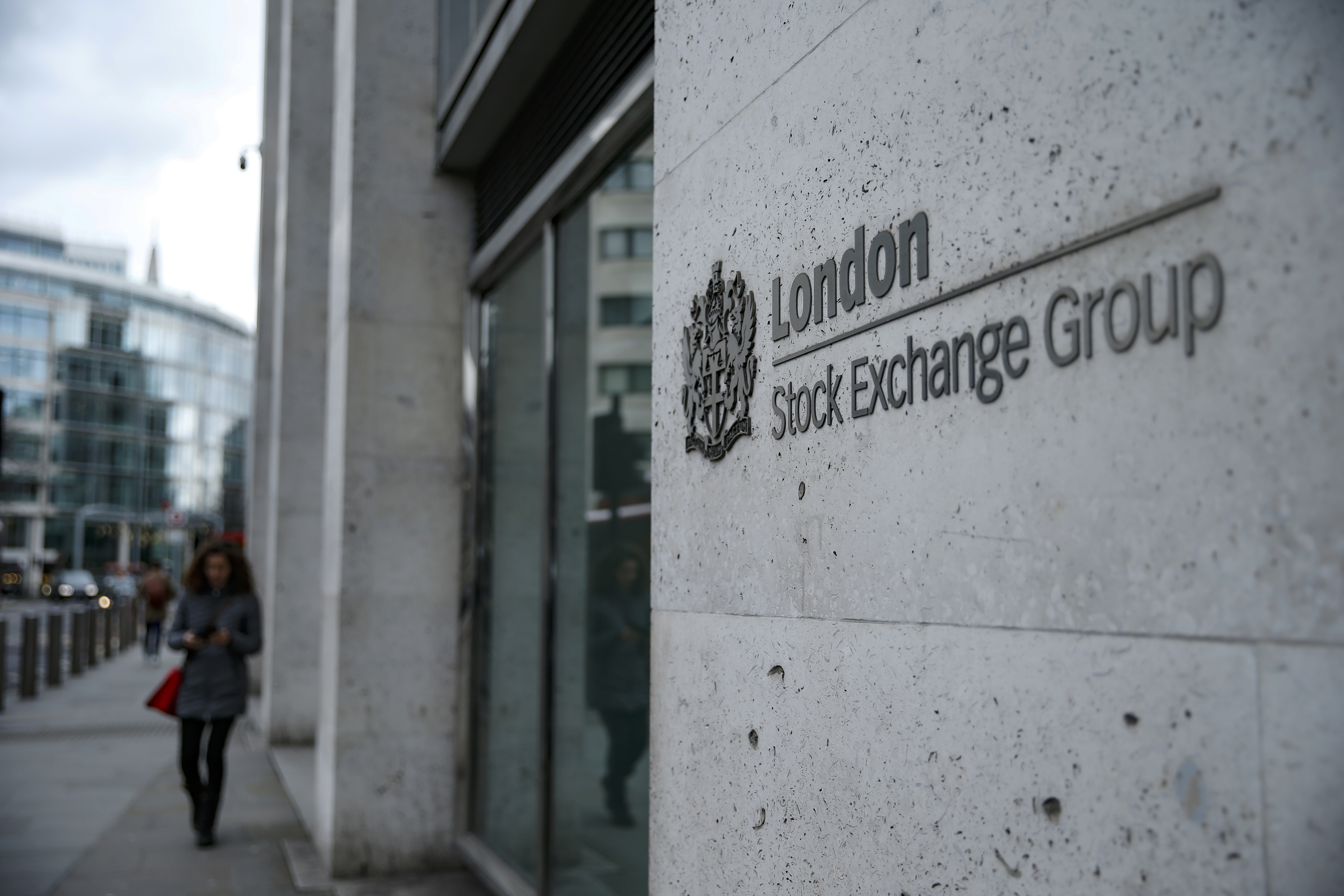A pedestrian walks past the London Stock Exchange (LSE) in London, U.K., on Friday, March 13, 2020. U.K. authorities have abandoned efforts to contain the spread of coronavirus and will focus on delaying the worst of the outbreak, as officials said as many as 10,000 Britons may be infected. Photographer: Hollie Adams/Bloomberg via Getty Images