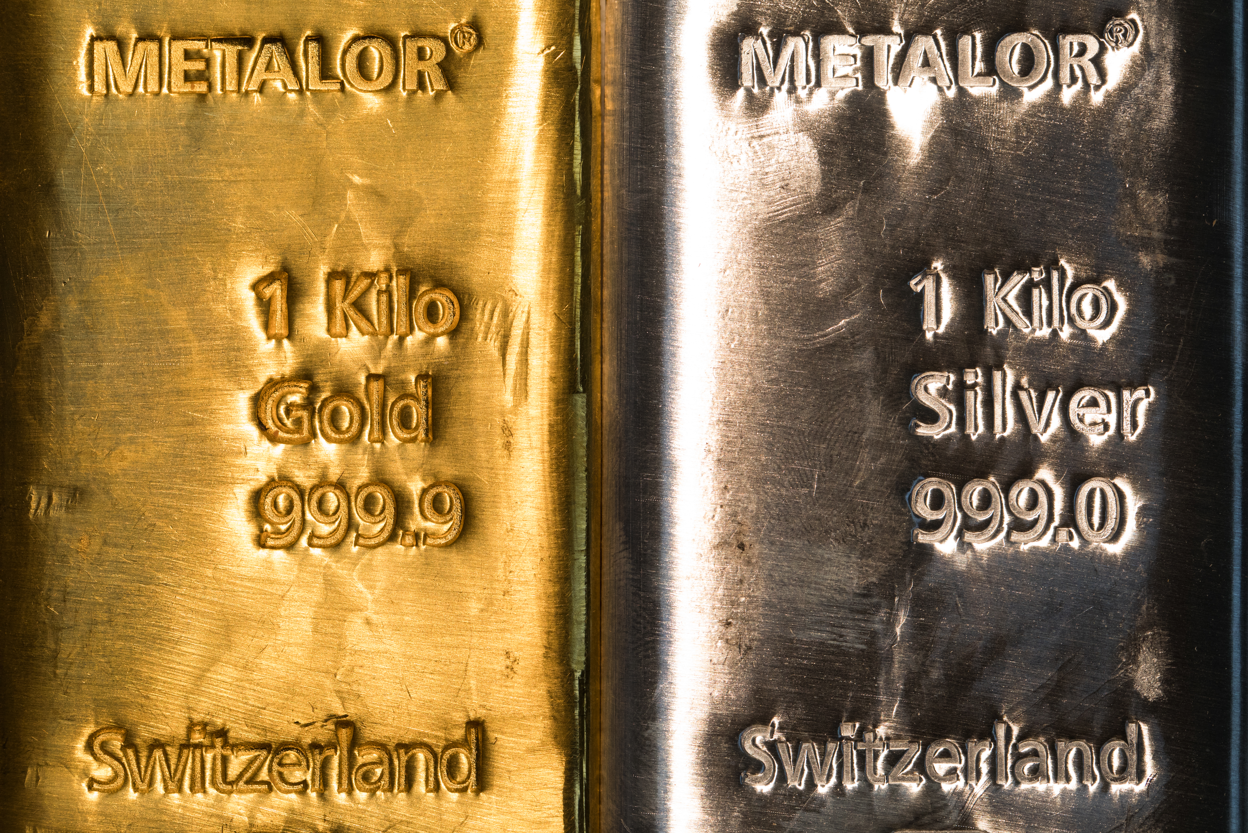A one-kilogram silver bar, right, sits next to a one-kilogram gold bar at Gold Investments Ltd. bullion dealers in this arranged photograph in London, U.K., on Wednesday, July 29, 2020. Gold held its ground after a record-setting rally as investors awaited the outcome of a Federal Reserve meeting amid expectations policy makers will remain dovish, potentially spurring more gains. Photographer: Chris Ratcliffe/Bloomberg via Getty Images