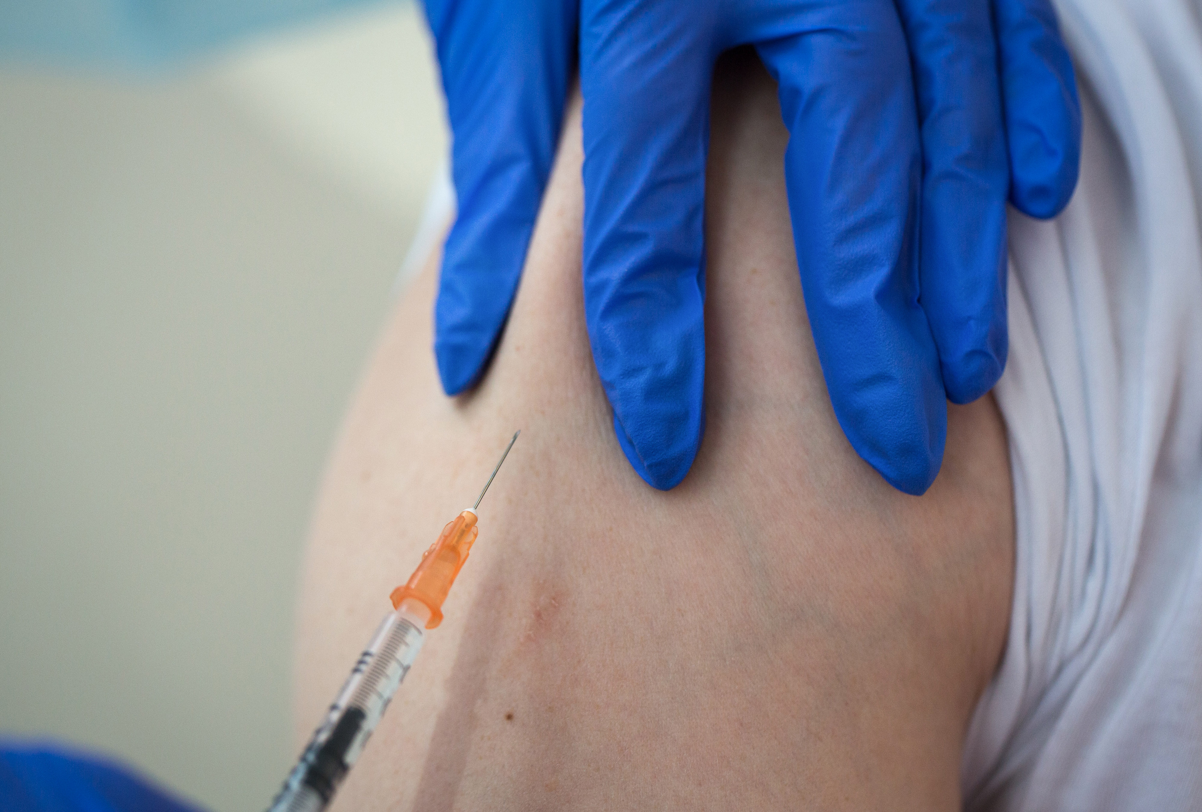 A medical worker prepares to inject a patient with a syringe in this arranged photograph taken at the Chaika Clinic in Moscow, Russia, on Monday, Aug. 10, 2020. Russia registered its first coronavirus vaccine, President Vladimir Putin said during a televised meeting with the government. Photographer: Andrey Rudakov/Bloomberg via Getty Images