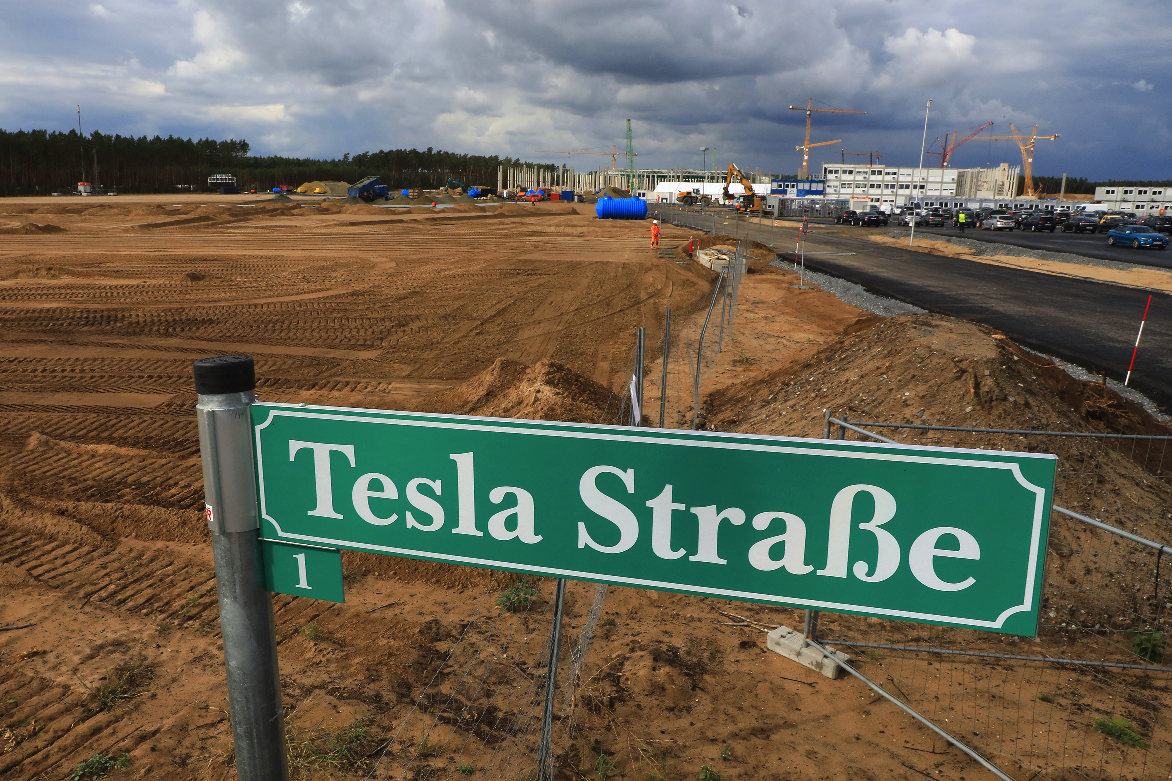 A 'Tesla Street' sign stands near a plot of land at the Tesla Inc. Gigafactory construction site in Gruenheide, Germany, on Wednesday, Sept. 2, 2020. Tesla is capitalizing on its status as the worlds most valuable automaker with a share offering to fund growth as the company doubles its factory count and attempts to solidify its position as electric-car global market leader. Photographer: Krisztian Bocsi/Bloomberg via Getty Images