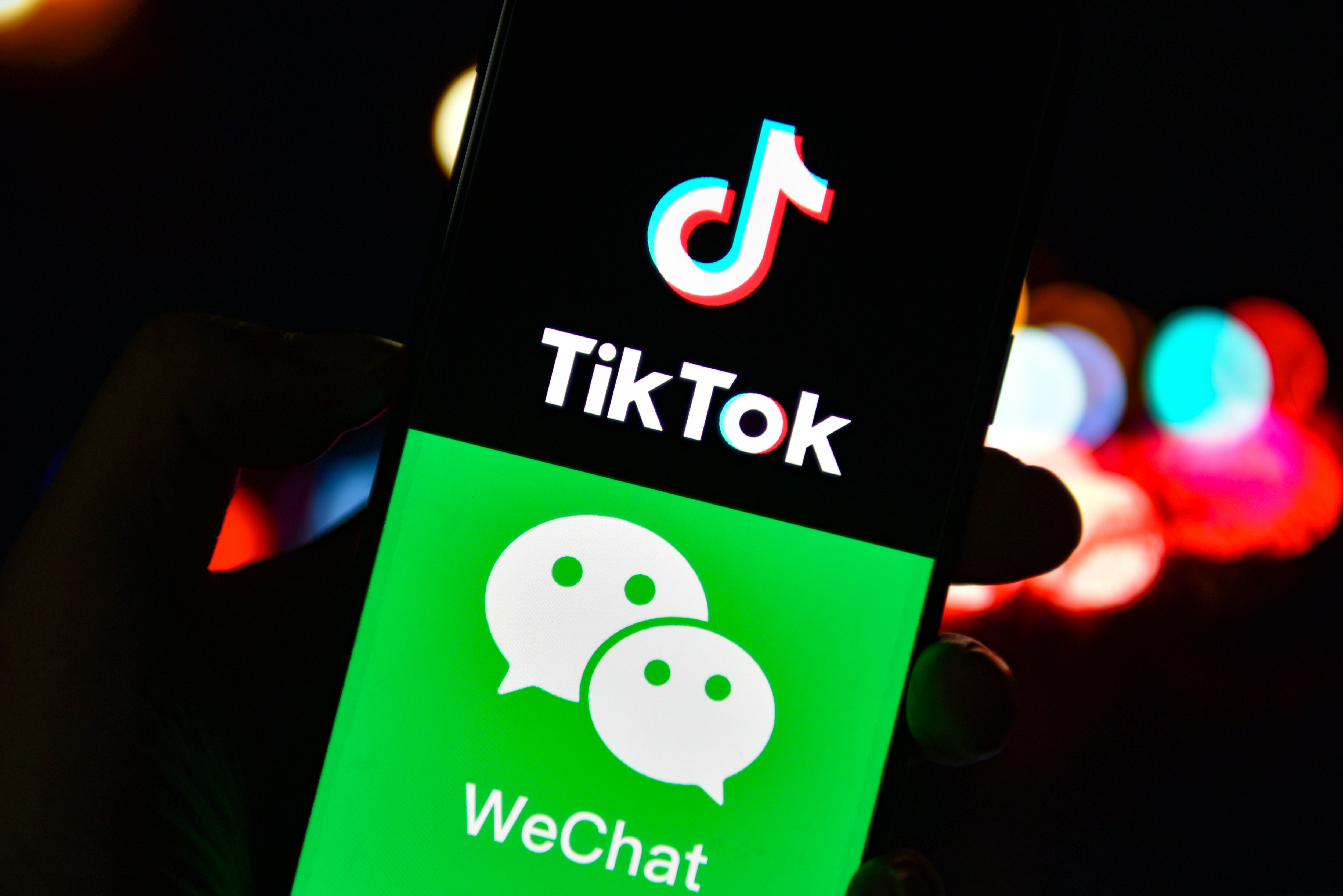 CHINA - 2020/09/20: In this photo illustration the TikTok and WeChat logos are seen displayed on a smartphone.