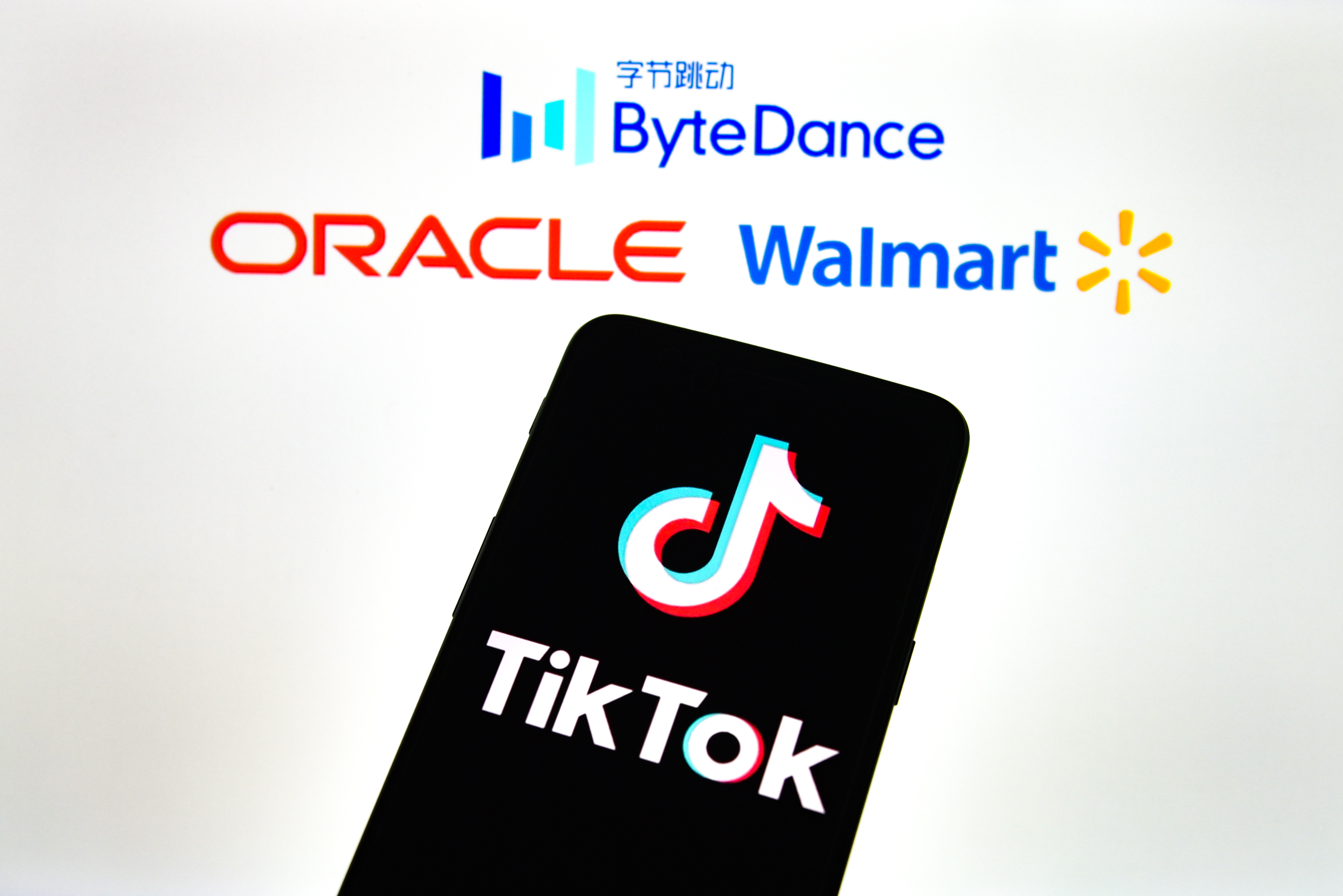 CHINA - 2020/09/20: In this photo illustration a TikTok logo is seen displayed on a smartphone with a ByteDance, Oracle and Walmart logo on the background. Sheldon Cooper—SOPA Images/LightRocket/Getty Images