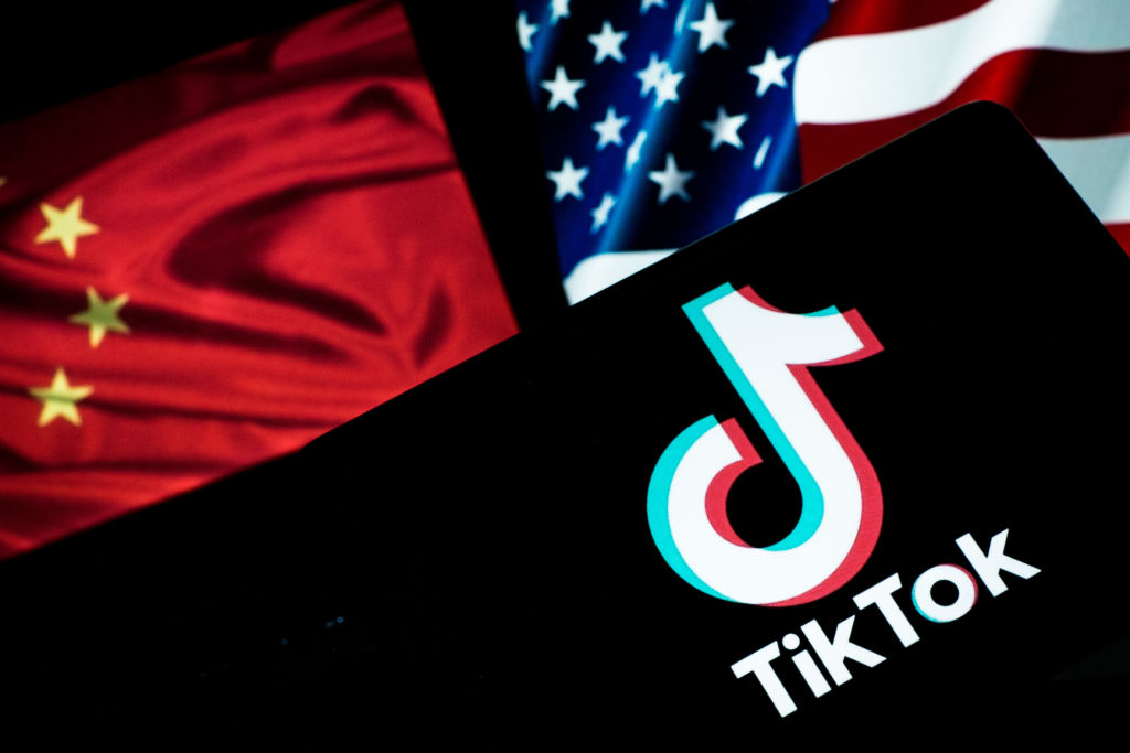 In this photo is seen the TikTok logo on a smartphone with an American and Chinese flag background on September 20, 2020 in Rome, Italy. Andrea Ronchini/NurPhoto via Getty Images