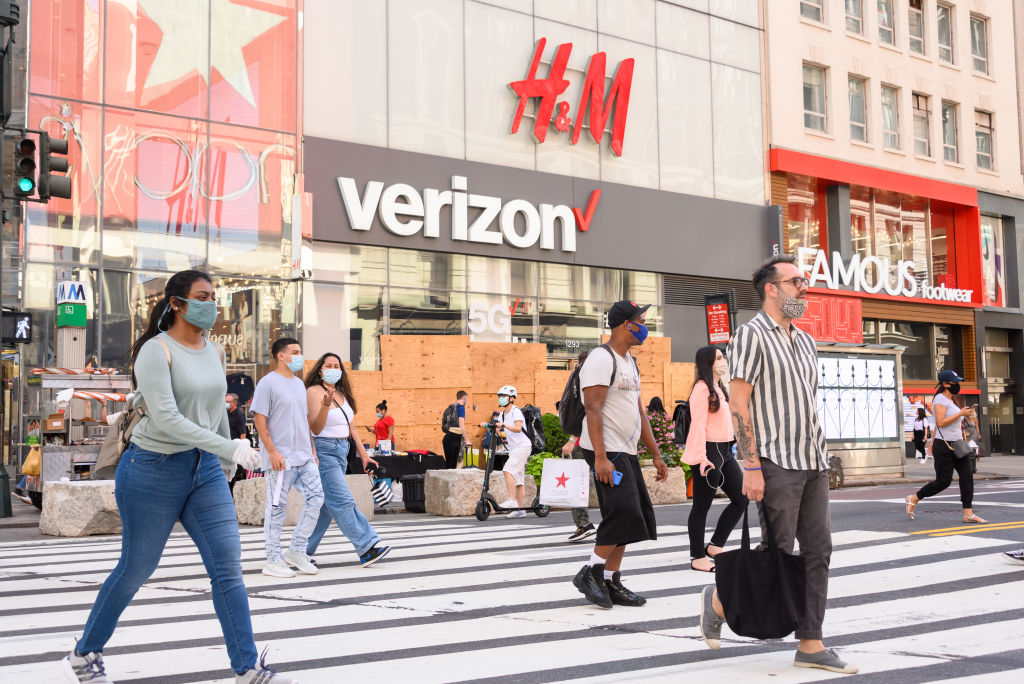 People wear protective face masks outside the Verizon and H&M stores in midtown as New York City moved into Phase 3 of re-opening following restrictions imposed to curb the coronavirus pandemic on July 14, 2020 in New York City. Noam Galai—Getty Images