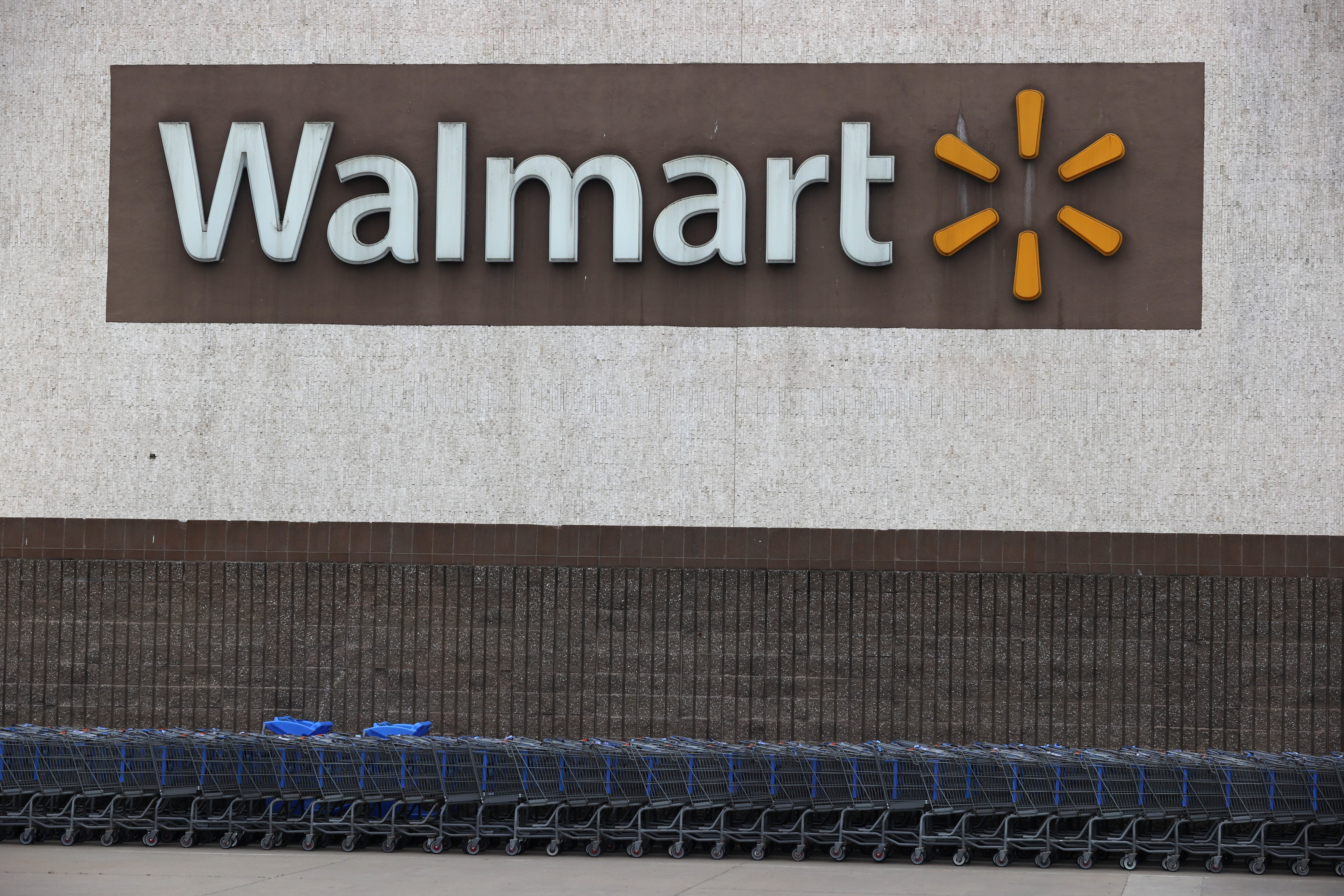 RICHMOND, CALIFORNIA - SEPTEMBER 03: Shopping carts sit in front of a Walmart store on September 03, 2020 in Richmond, California. Walmart has announced plans to launch Walmart Plus delivery service to compete with Amazon Prime. The $98 per year service will offer free delivery of food and items available from nearby stores. (Photo by Justin Sullivan/Getty Images)