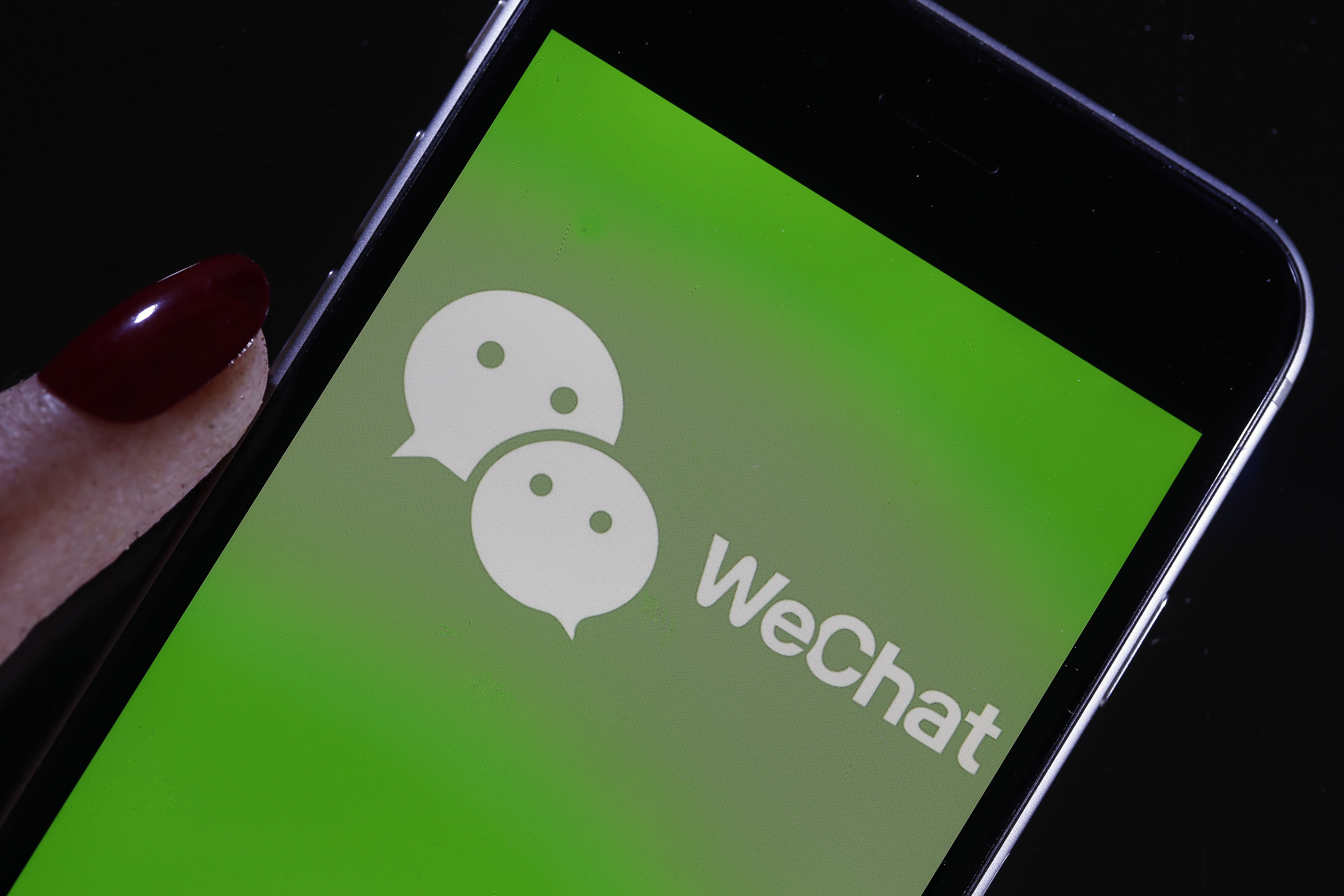 PARIS, FRANCE - SEPTEMBER 18: In this photo illustration the logo of Chinese media app for creating and sharing short videos WeChat is displayed on the screen of a smartphone on September 18, 2020 in Paris, France. The United States on Friday announced a ban on downloading TikTok and WeChat apps, which are very popular with young people, from Sunday, with the two Chinese apps facing accusations of spying for the benefit of China.